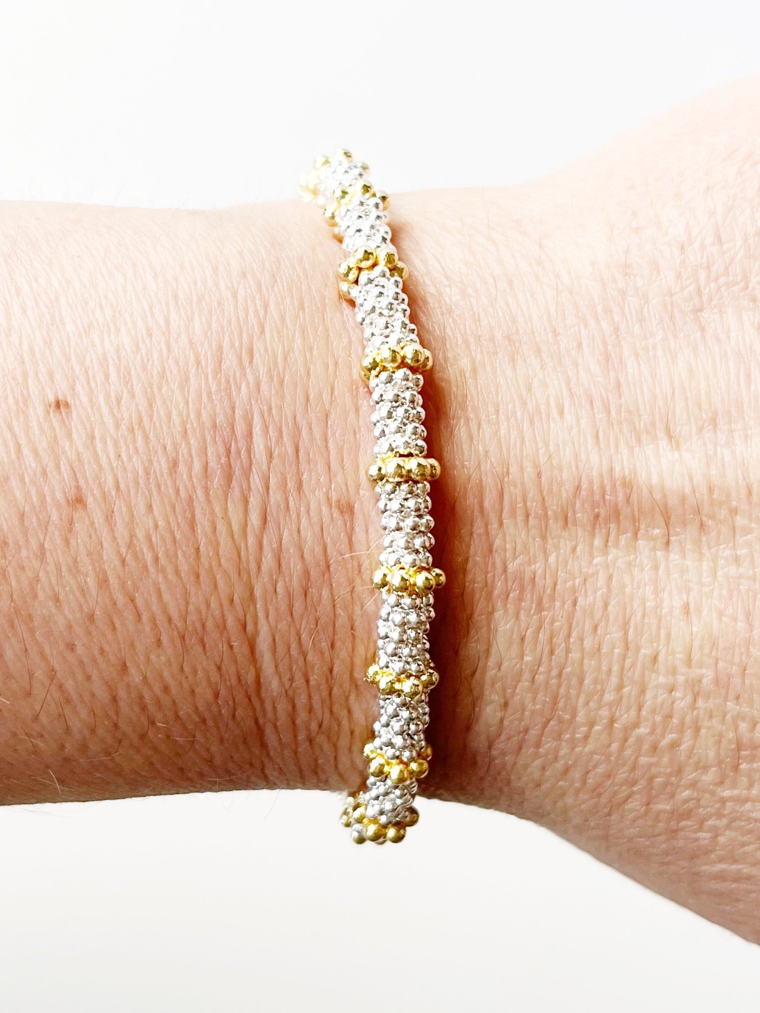 Silver stacking bracelet with gold accents