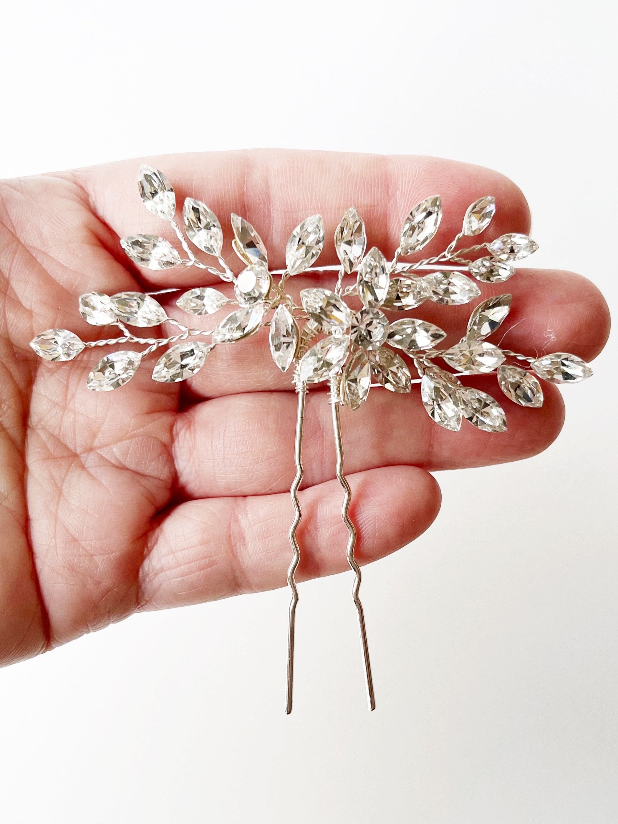 crystal bridal hairpiece displayed on hand