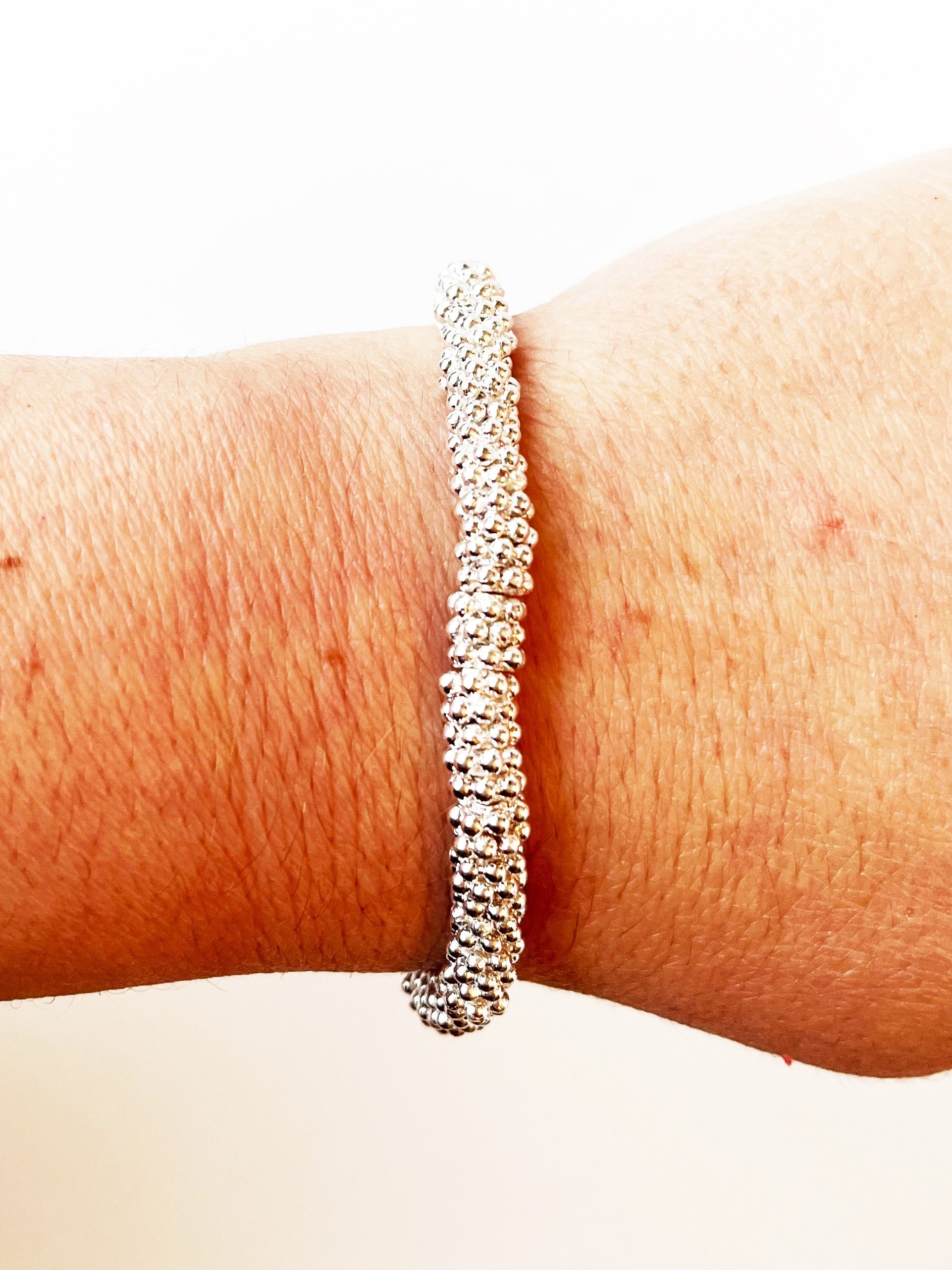 medium silver stacking bracelets displayed on wrist