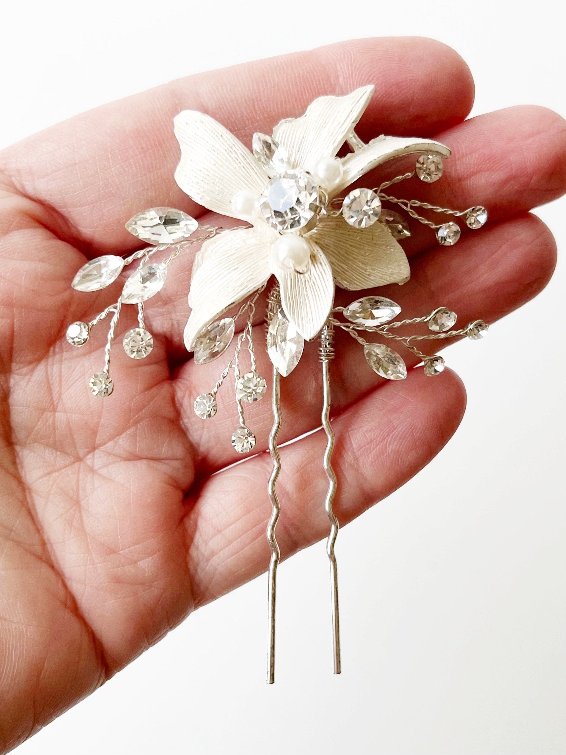 crystal and flower bridal hair piece displayed on hand