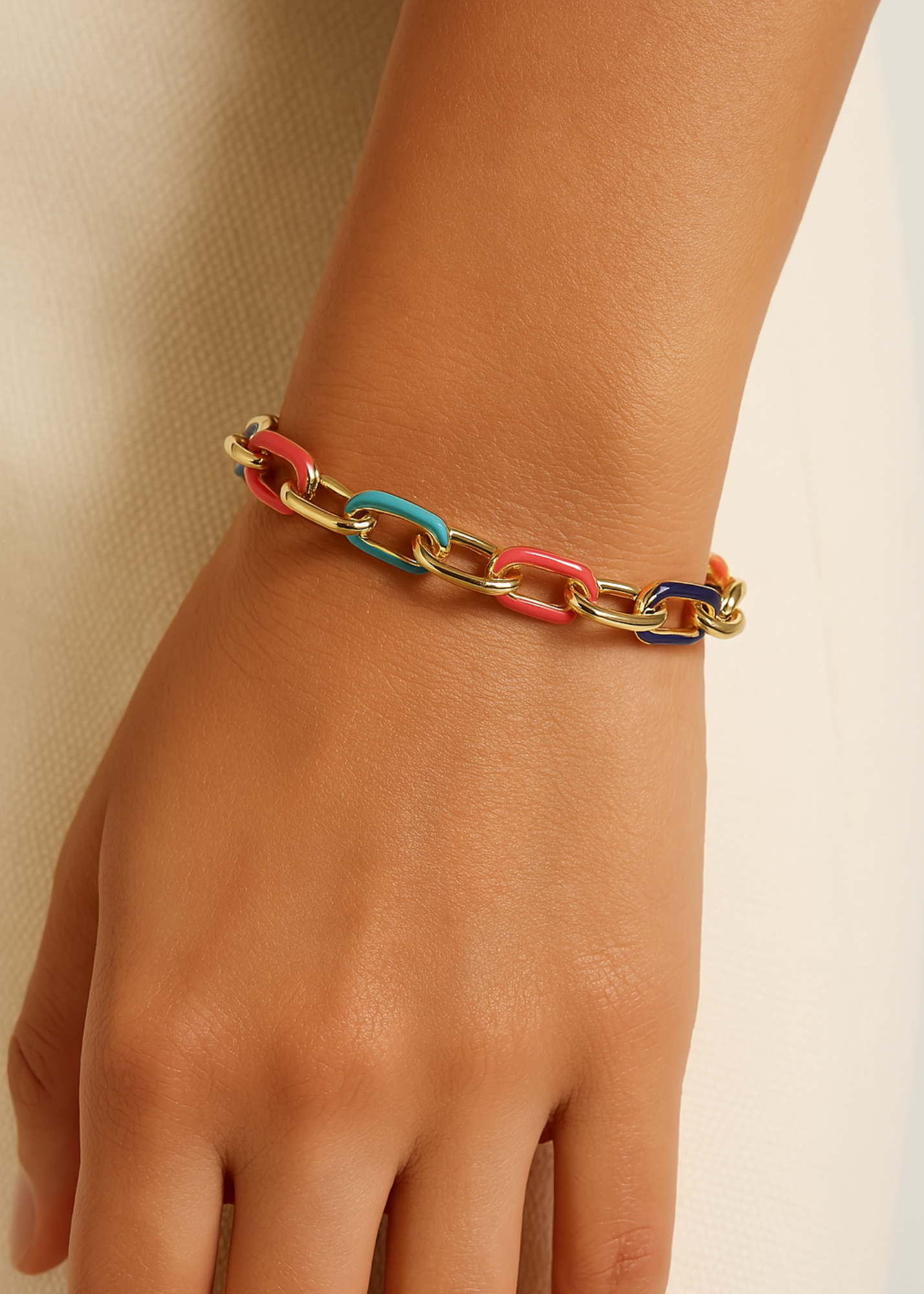 gold enamel bracelet on wrist