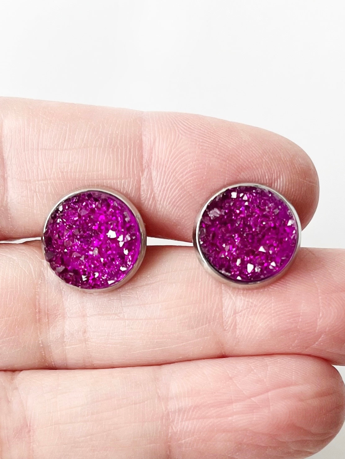 sangria druzy everyday earrings displayed on hand