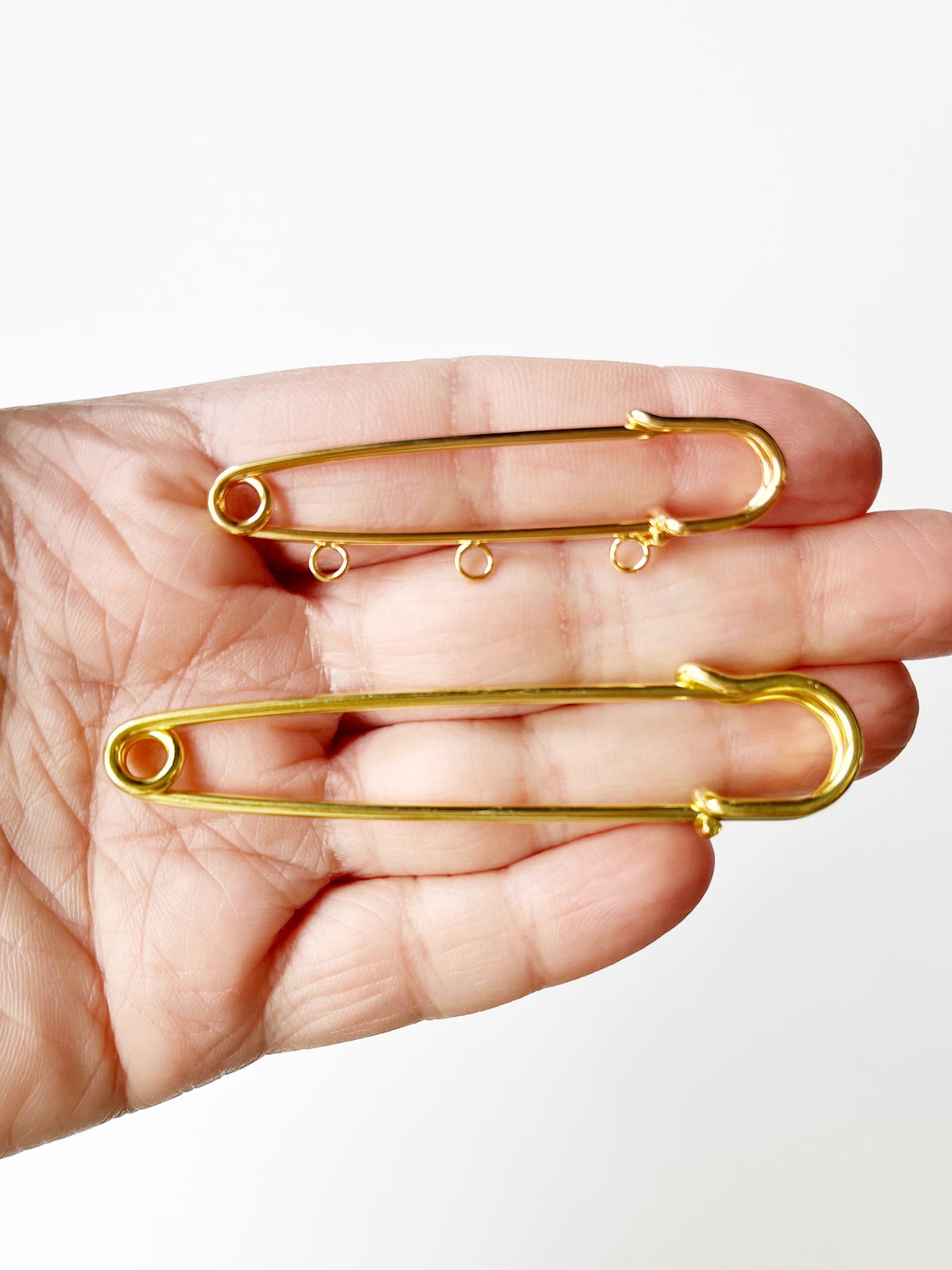 kilt pin brooch on hand