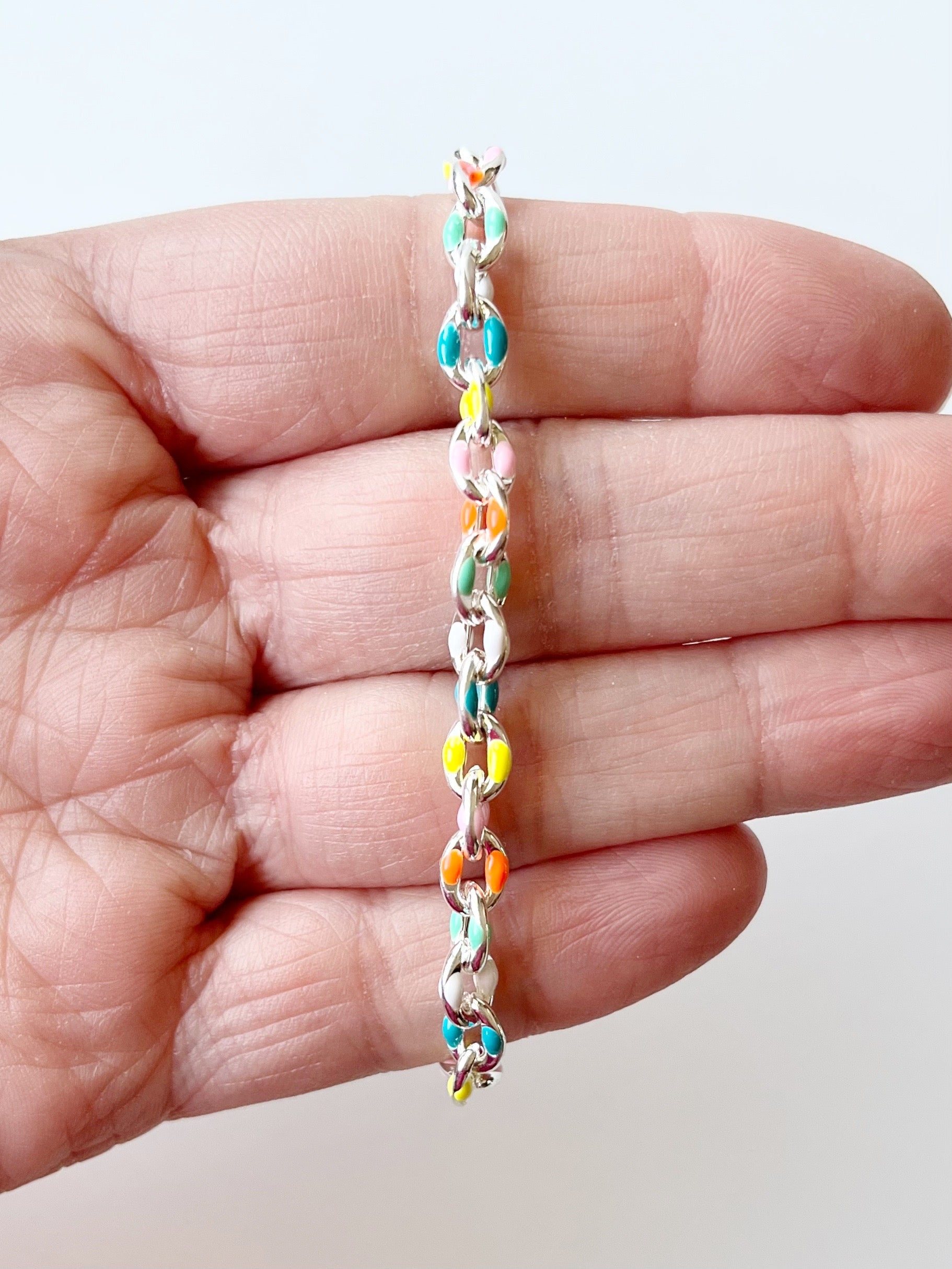 rainbow and silver chain bracelet displayed on hand