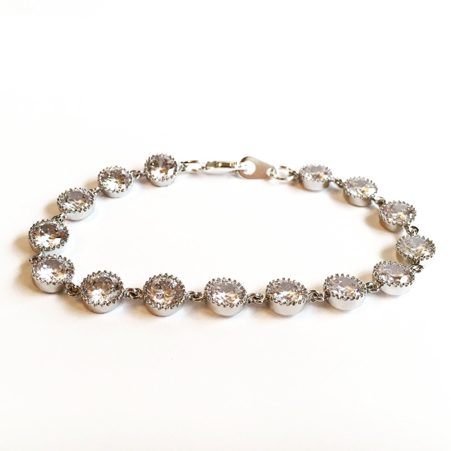 Cubic zirconia crystals set in silver color rhodium plated brass bracelet. 