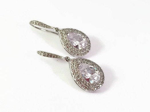 Double Halo clear Cubic Zirconia Teardrop Crystal earrings in a silver colored rhodium plated brass setting.