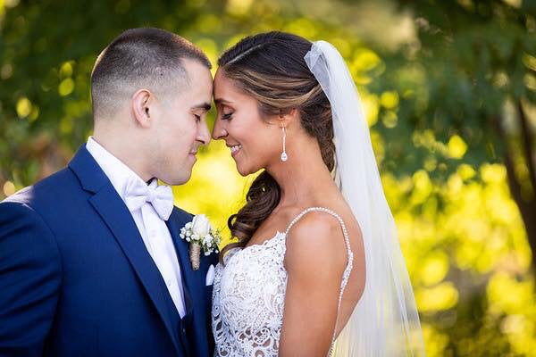Bride wearing Long Clear cubic zirconia Crystal Drop Earrings in a silver colored rhodium plated brass setting.