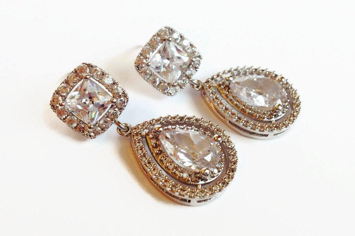 Cubic zirconia teardrop crystal earrings in a silver colored rhodium plated brass setting.