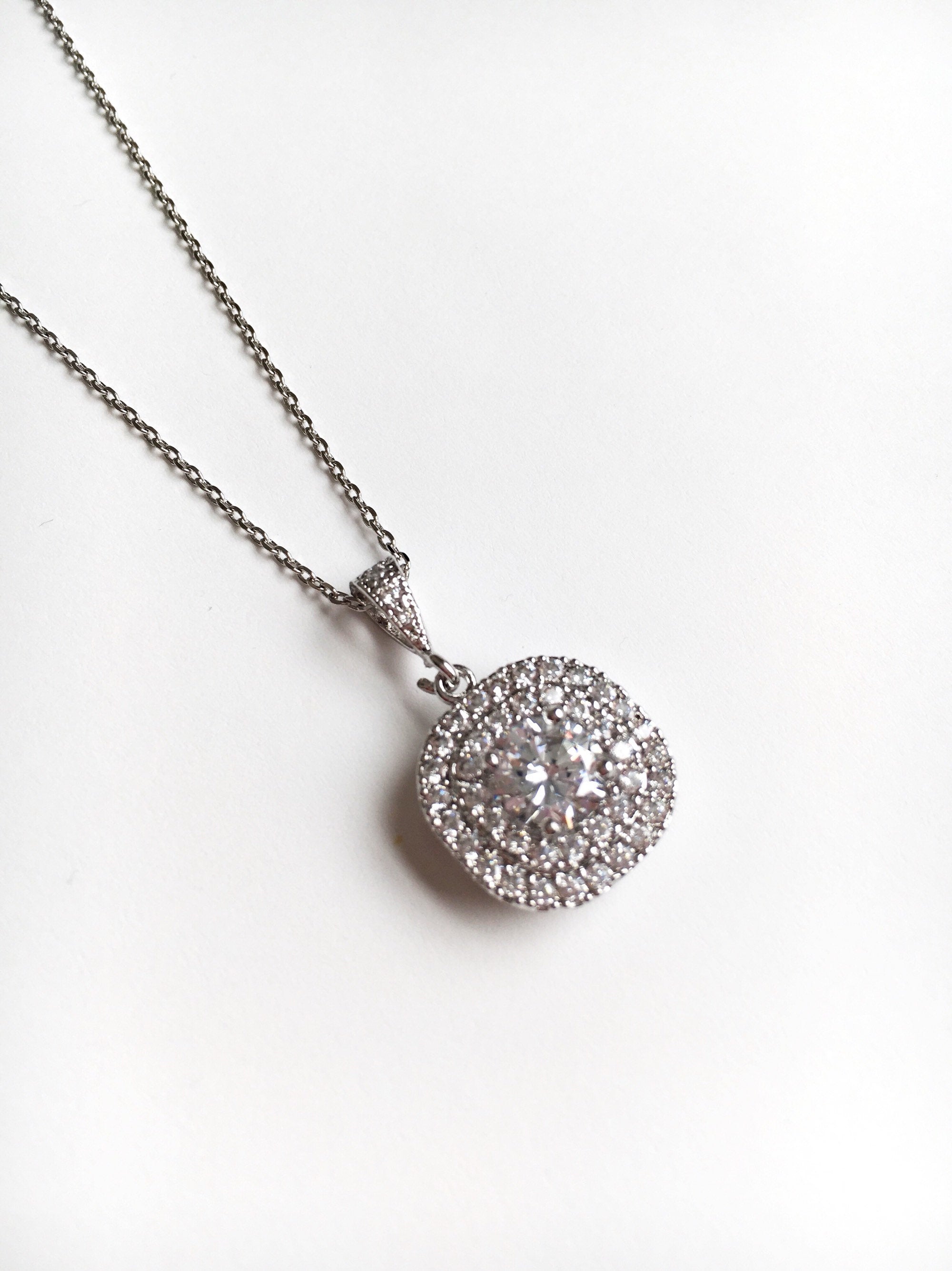 Cubic zirconia crystal pendant set in silver color rhodium plated brass necklace