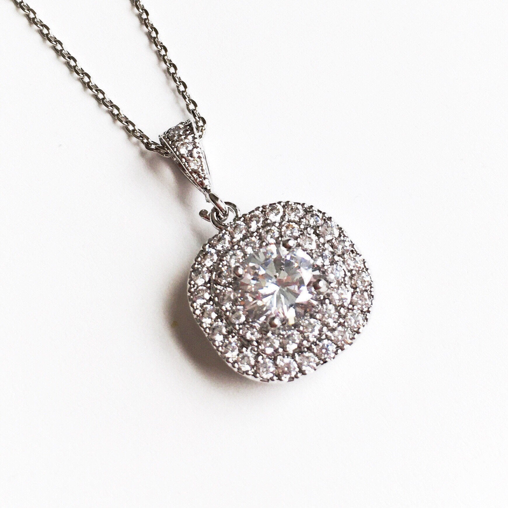 Close up of Cubic zirconia crystal pendant set in silver color rhodium plated brass necklace