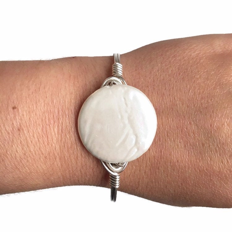 Silver bangle bracelet on womens wrist