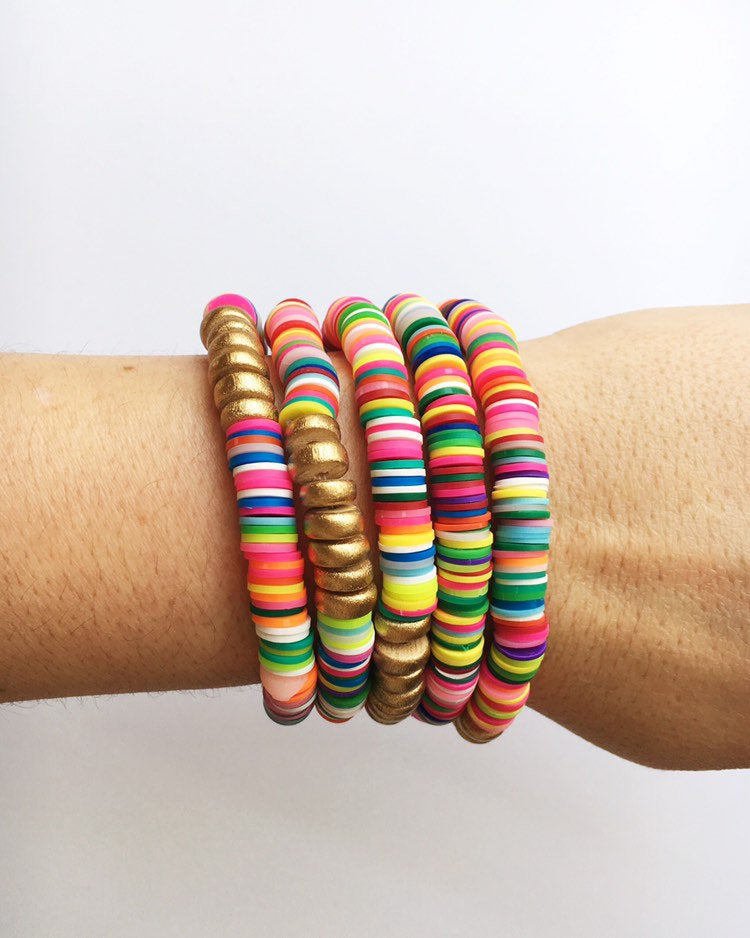 rainbow stacking bracelets on wrist