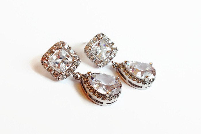 Cubic zirconia teardrop crystals earrings in a silver colored rhodium plated brass setting.