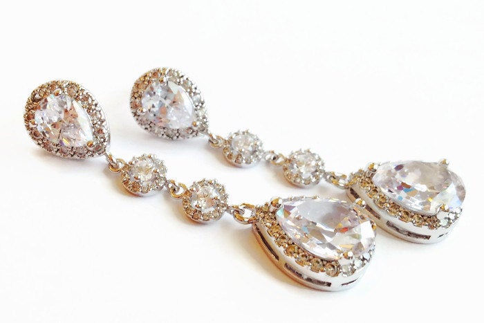 Long Clear cubic zirconia teardrop crystal earrings in a silver colored rhodium plated brass setting.