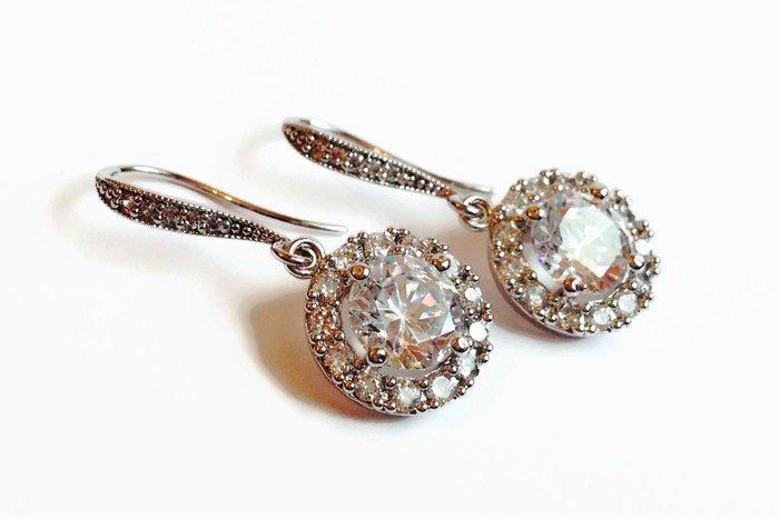 Round Clear cubic zirconia Crystal Stud Earrings with halo in a silver colored rhodium plated brass setting