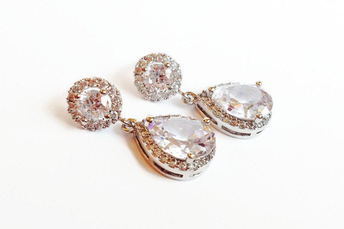 Clear cubic zirconia teardrop crystals in a silver colored rhodium plated brass setting earrings