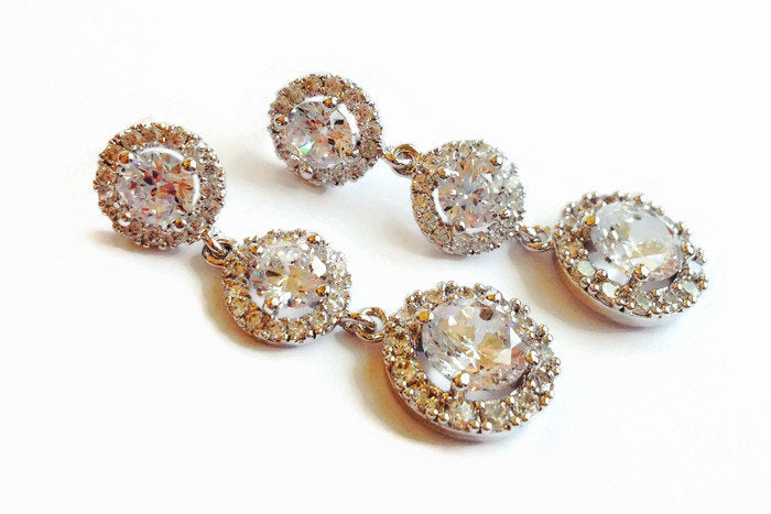 Long Cubic zirconia round crystal earrings in a silver colored rhodium plated brass setting