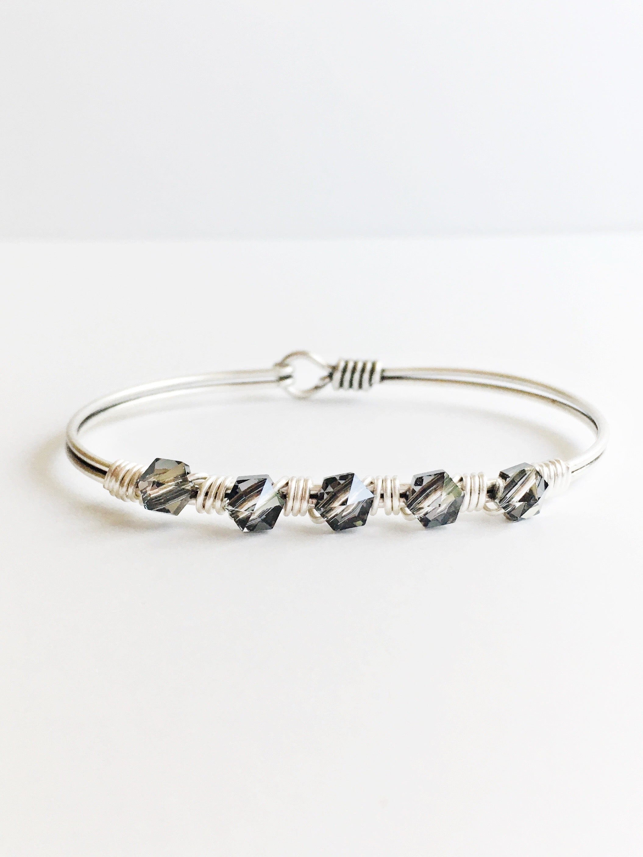 Hand wired grey crystals and silver bangle bracelet.