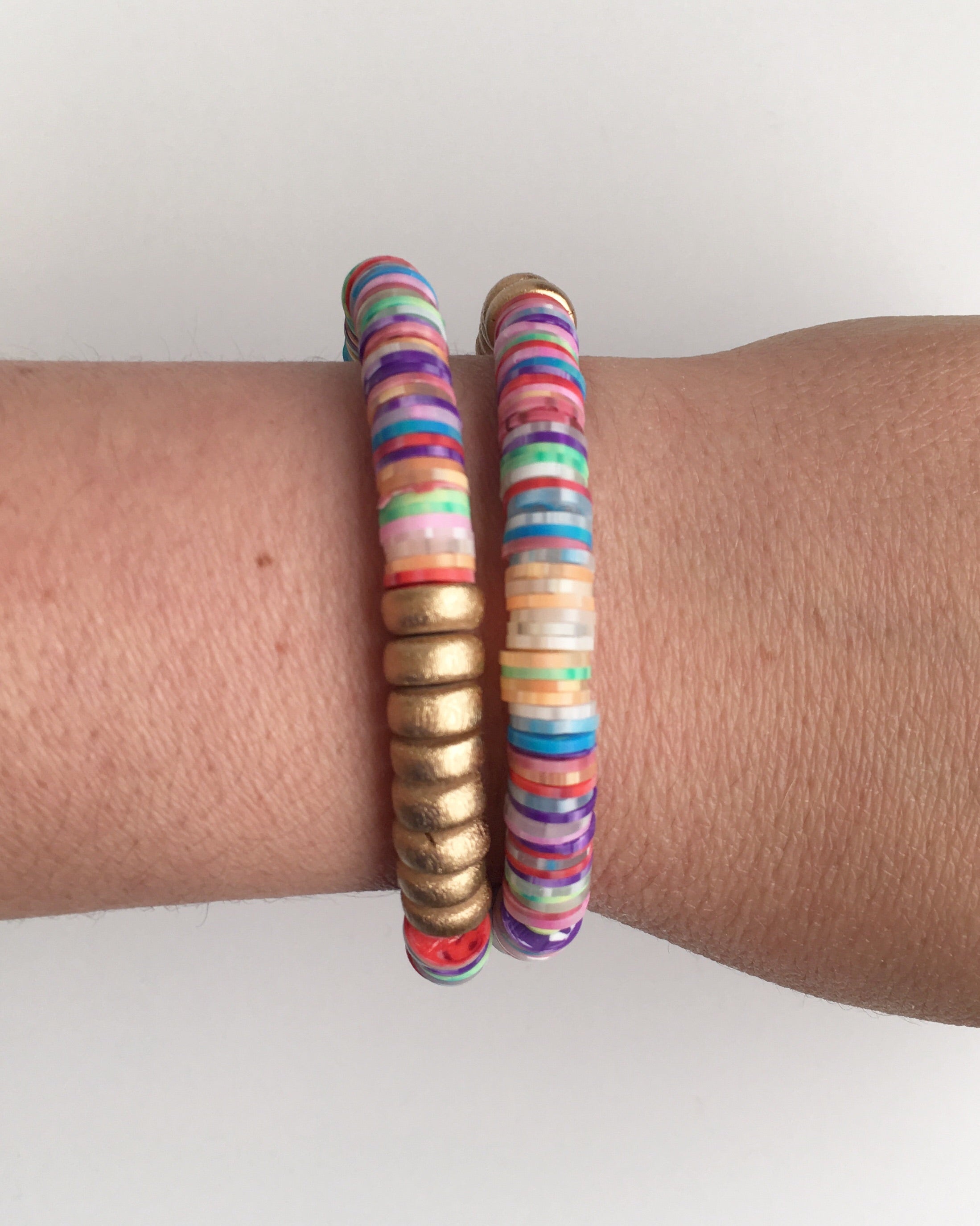 tie dye and gold bead bracelets on wrist