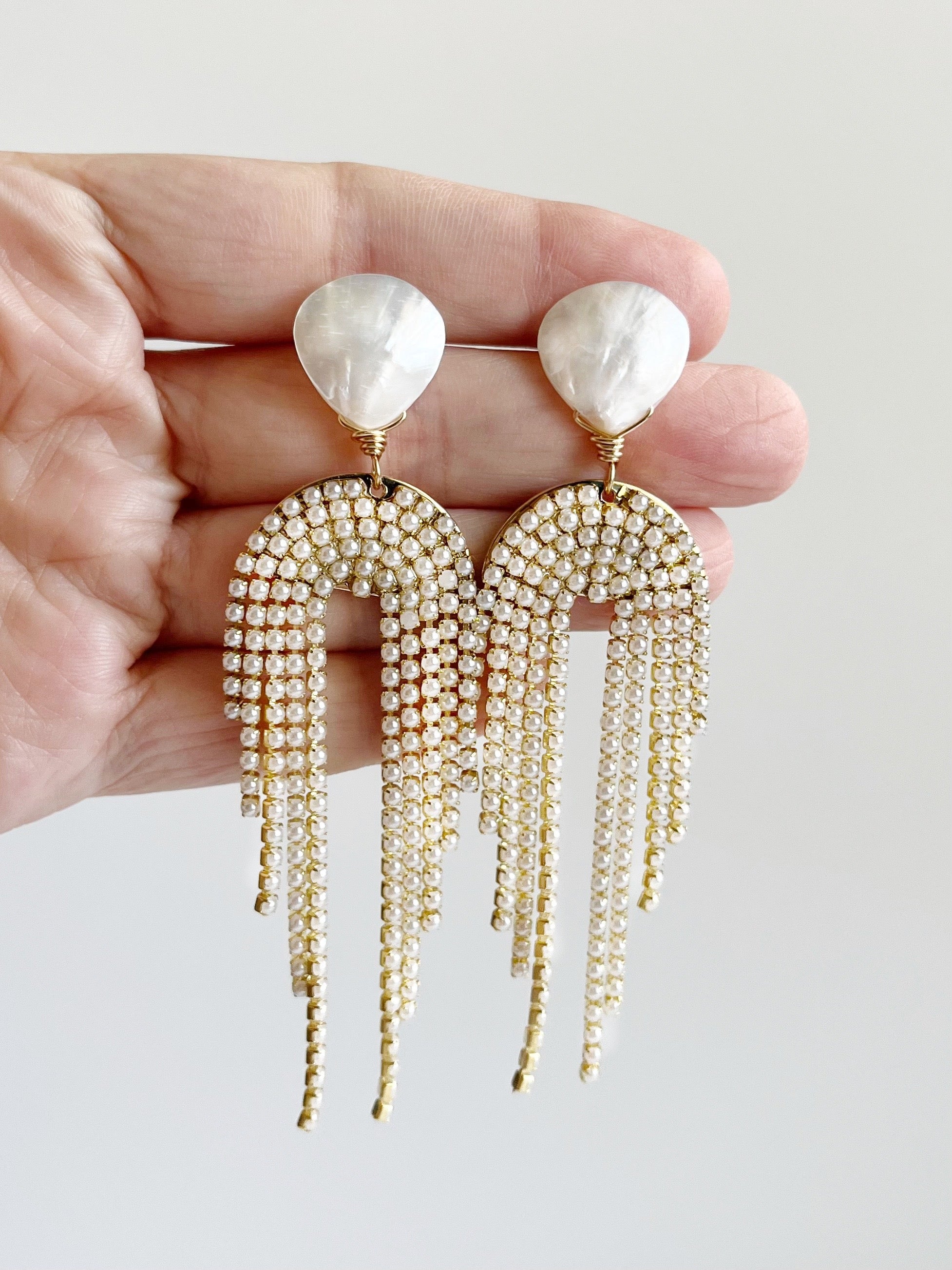 statement earrings displayed on hand