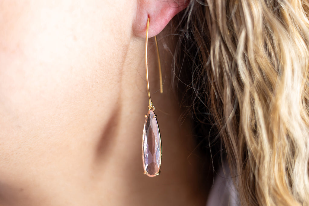 pink and gold minimalist earrings shown on ear