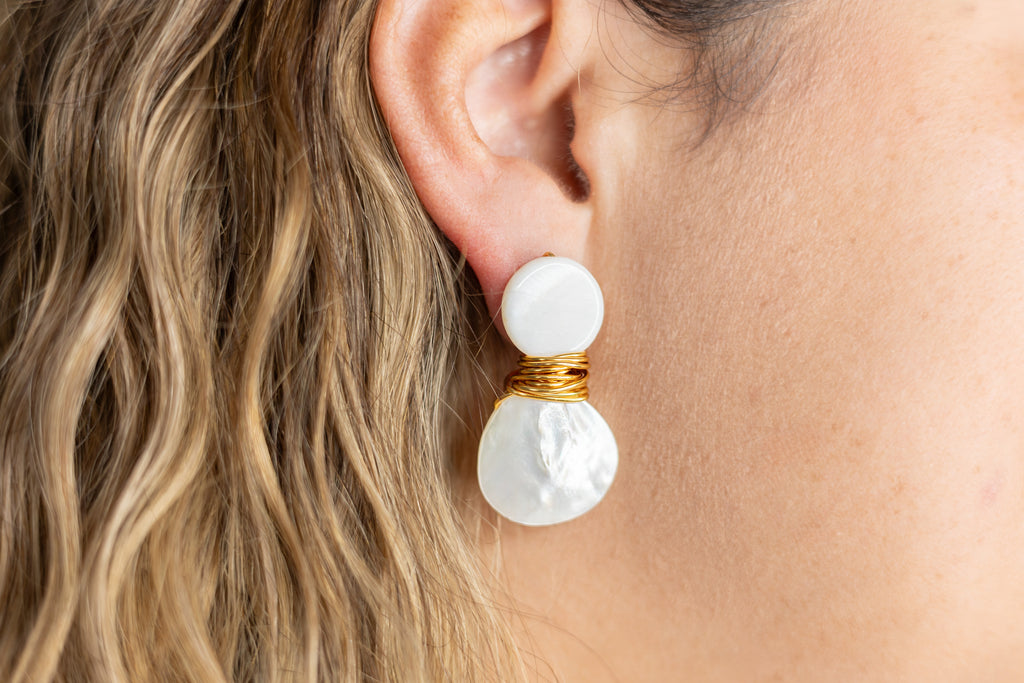 pearl drop earrings on woman