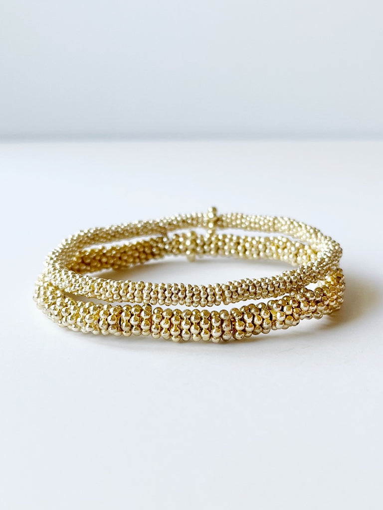 two gold bead bracelets