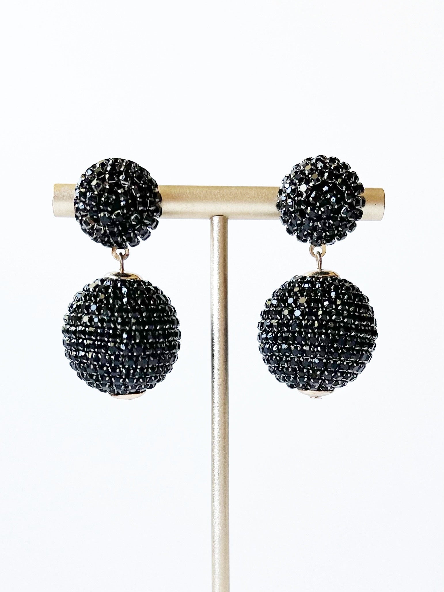 black crystal dangle earrings on gold stand