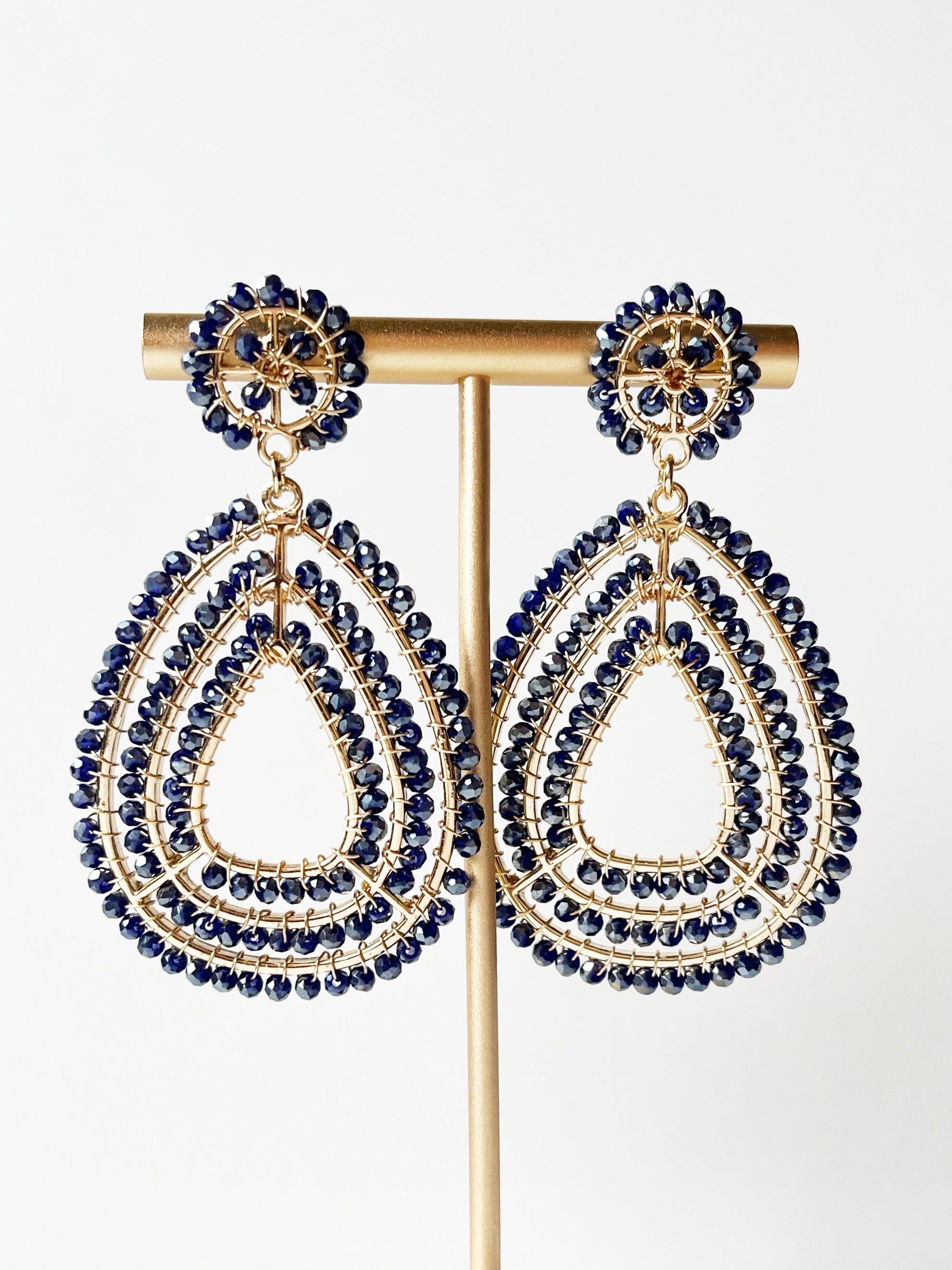 black teardrop earrings on gold stand