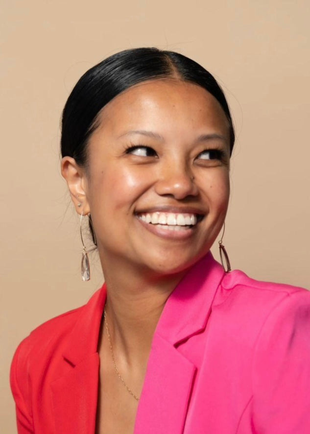 woman wearing crystal pendant earrings