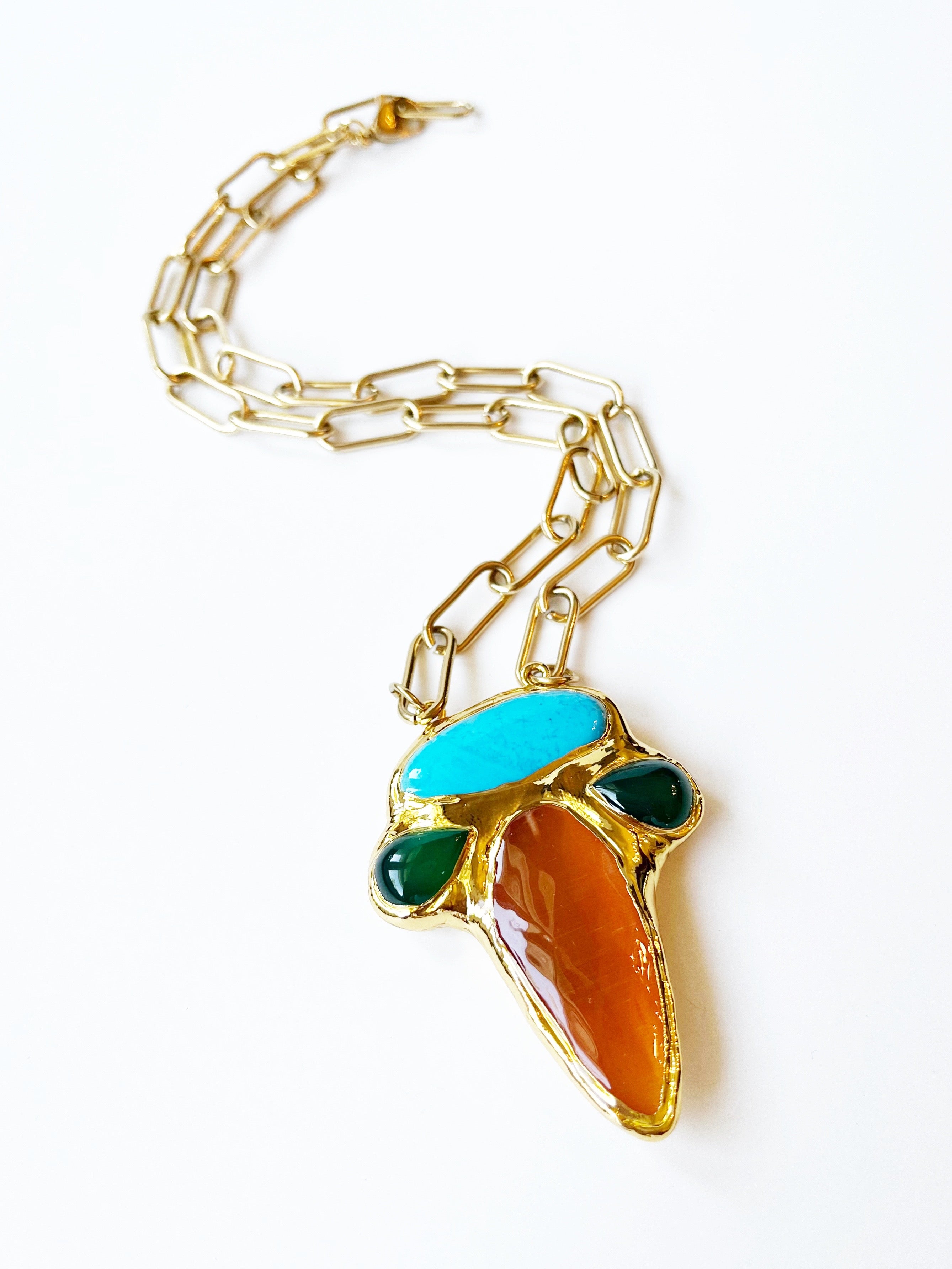Gold chain necklace with a colorful pendant on a white background