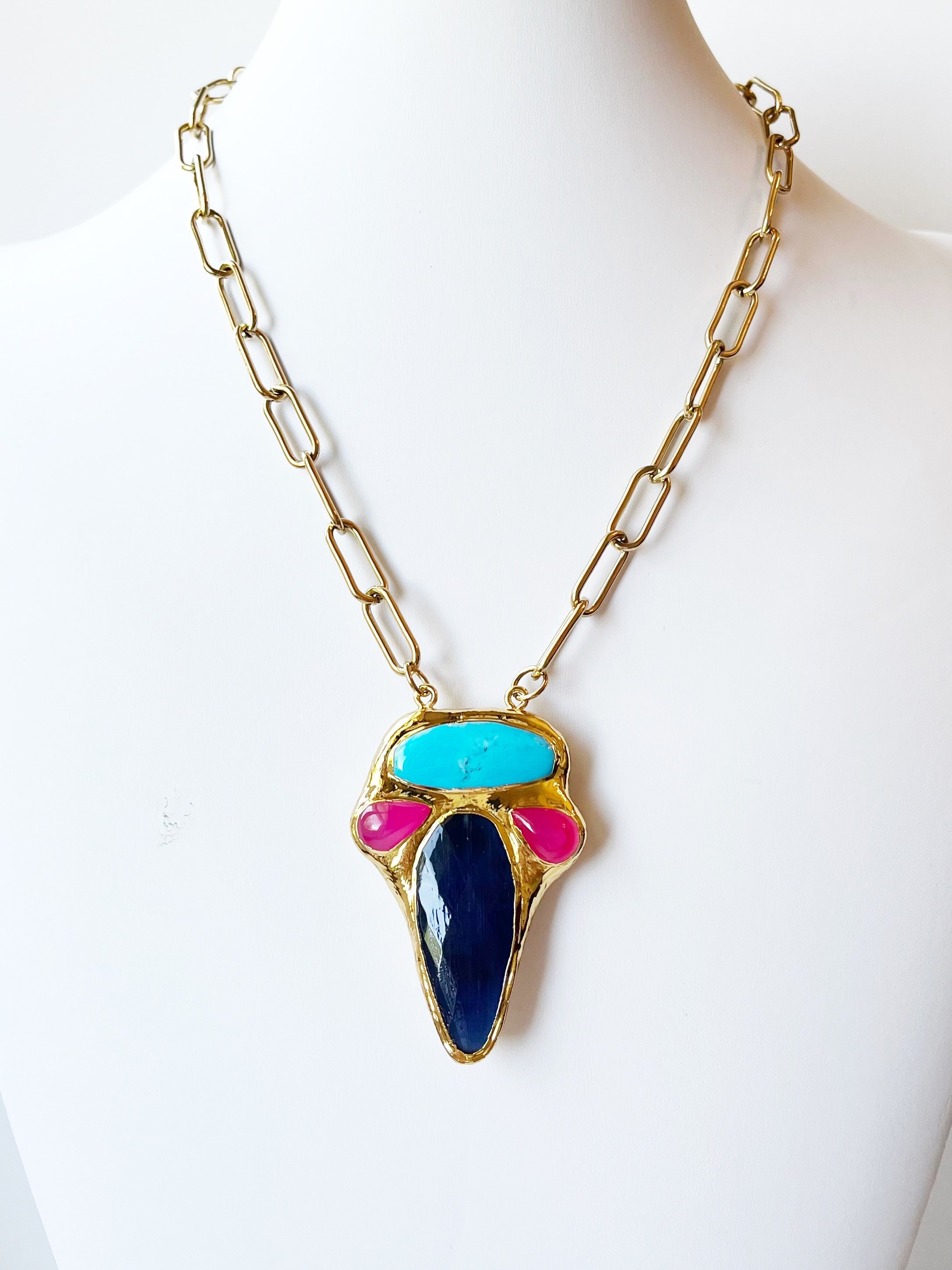 Necklace with colorful pendant on a mannequin against a white background