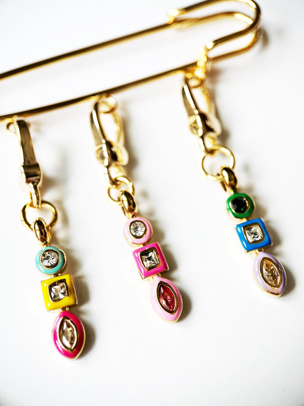 gold brooch with enamel charms