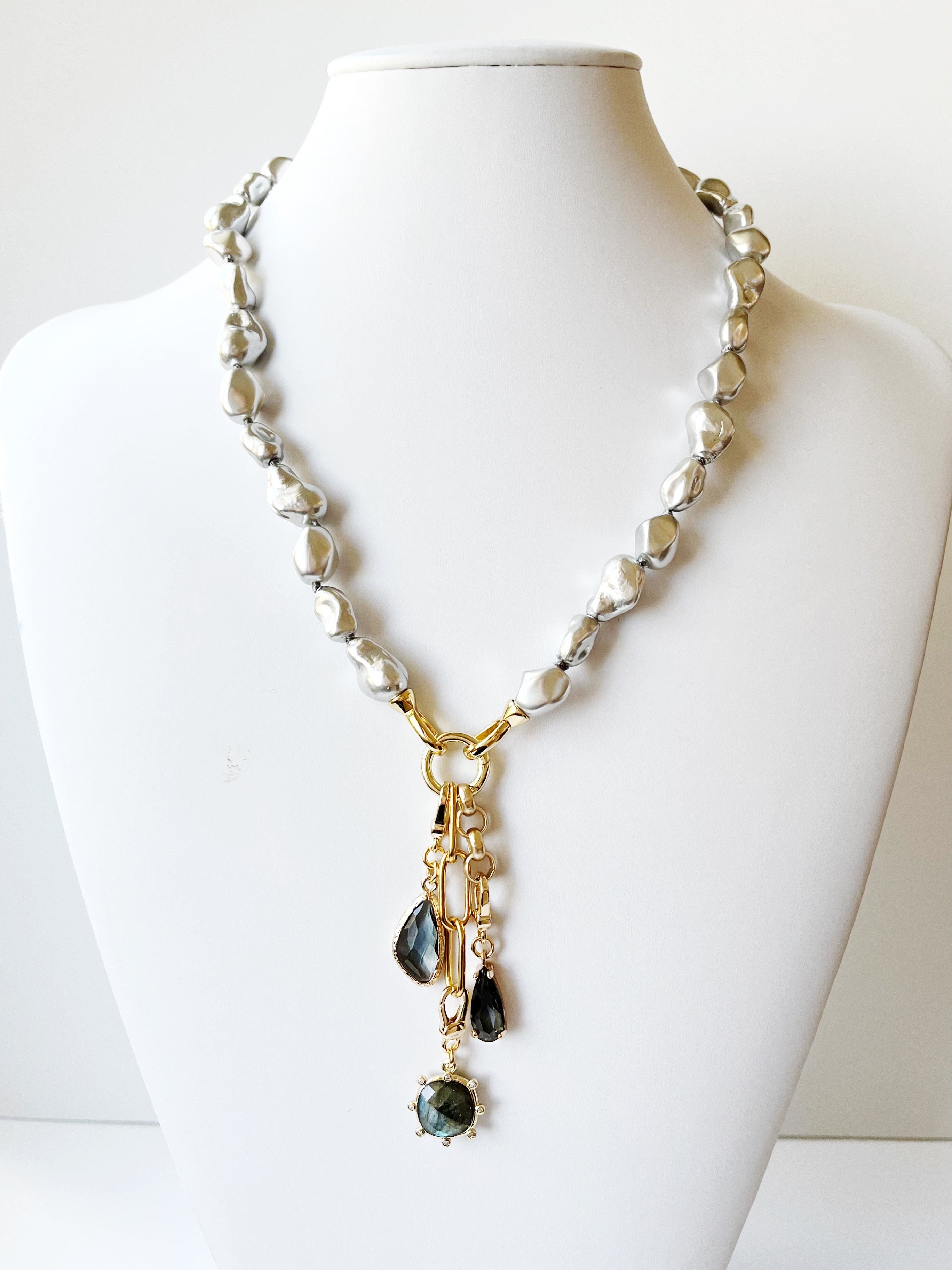 Necklace with beads and gold accents on a mannequin
