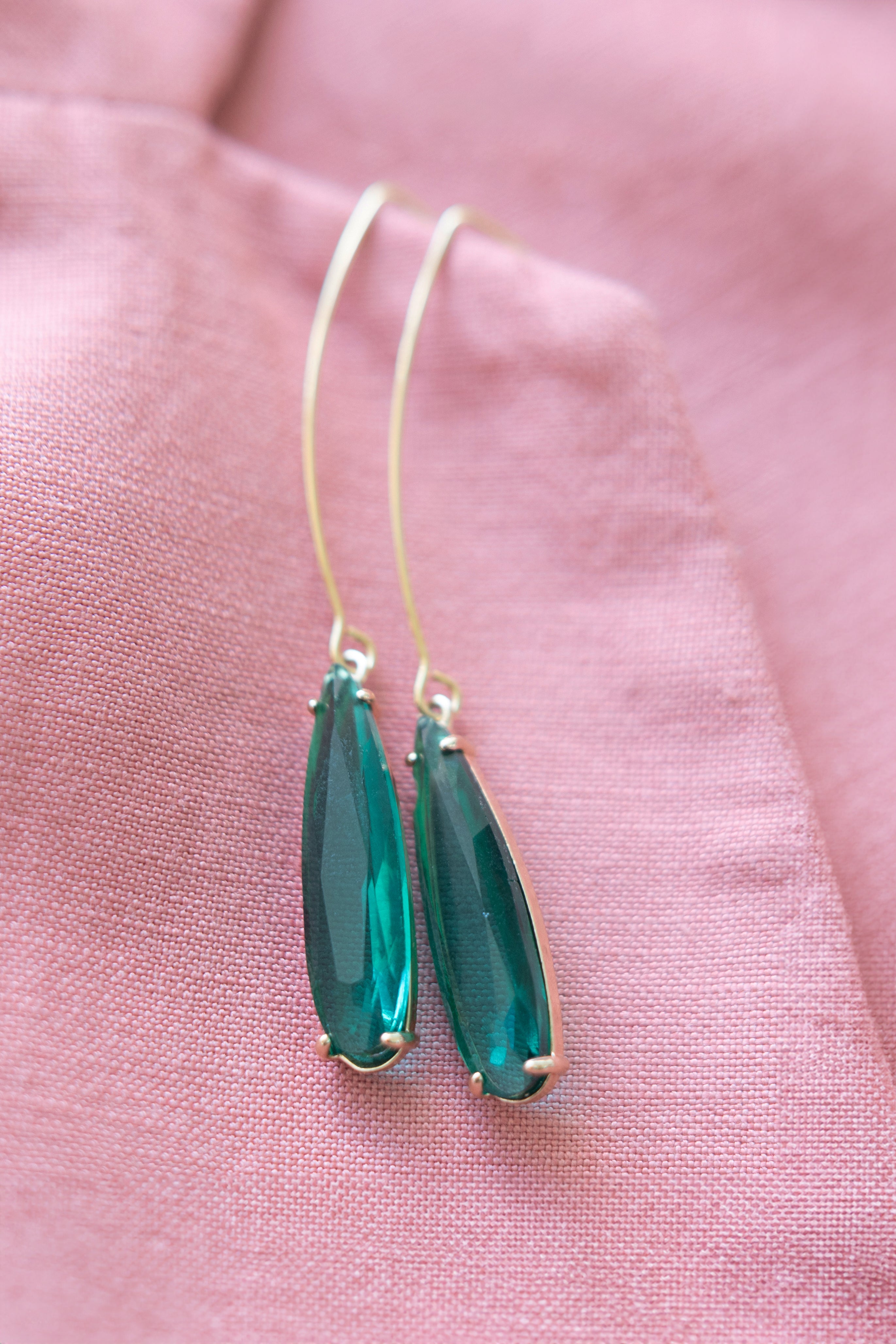 green earrings with pink background