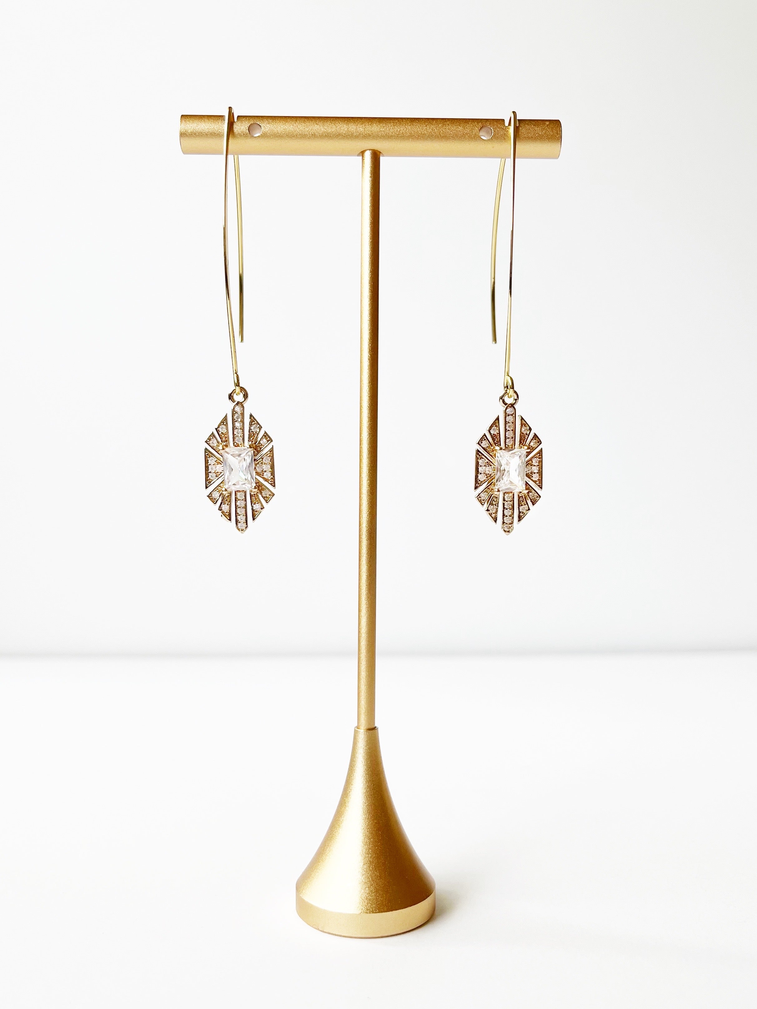 crystal and gold threader earrings displayed on gold earring stand