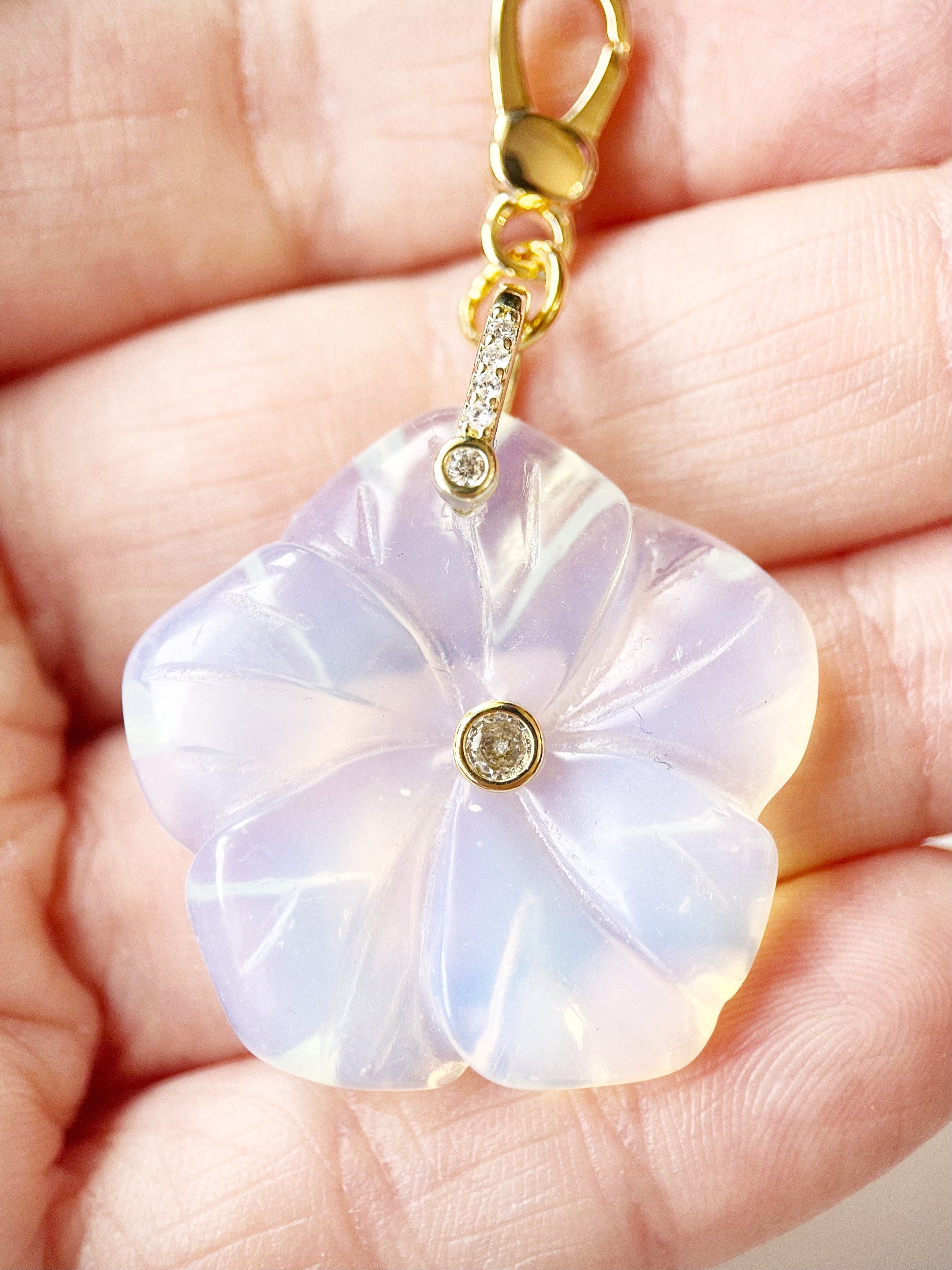 opal flower charm displayed on hand