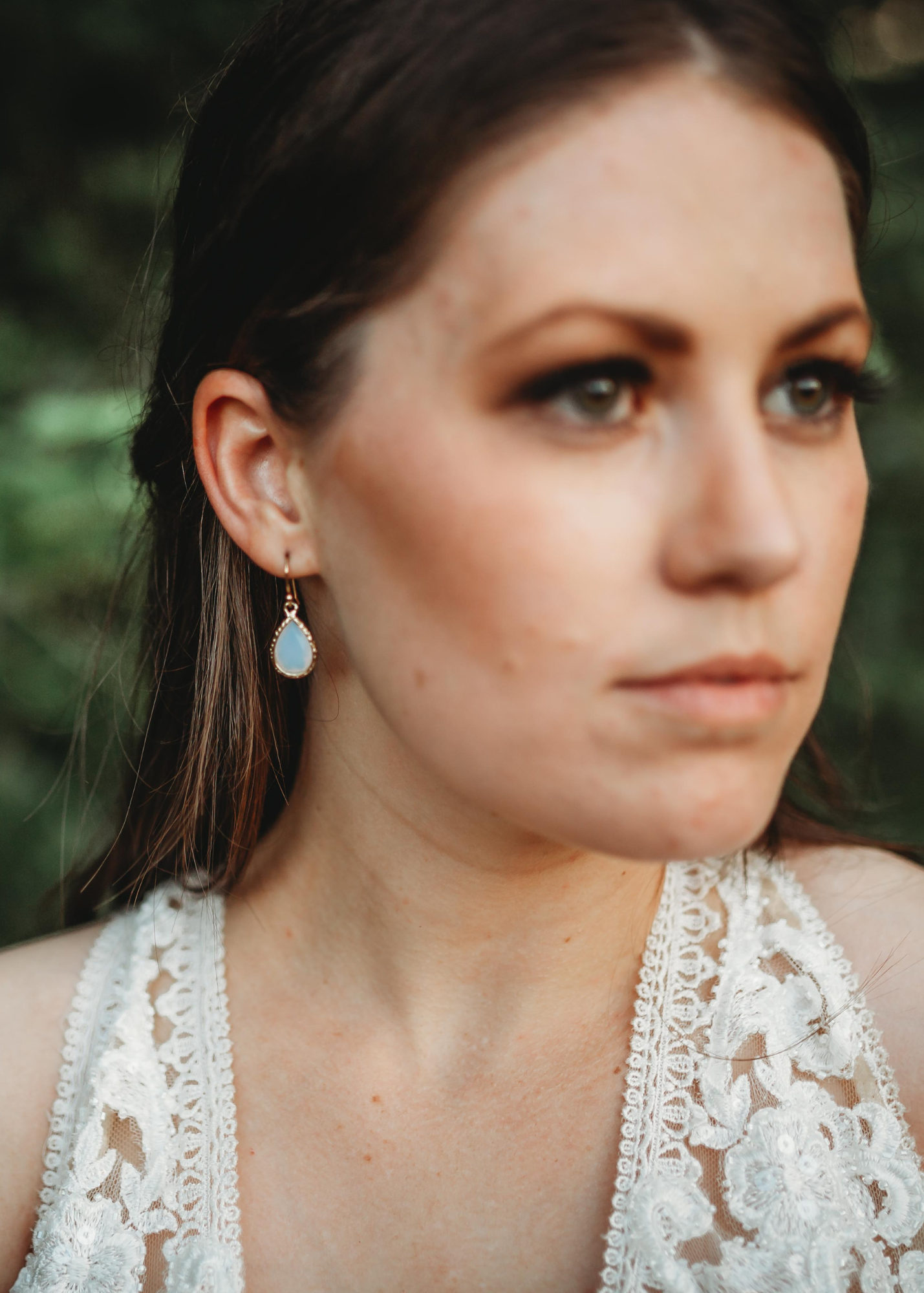 white opal dangle earrings modeled on woman