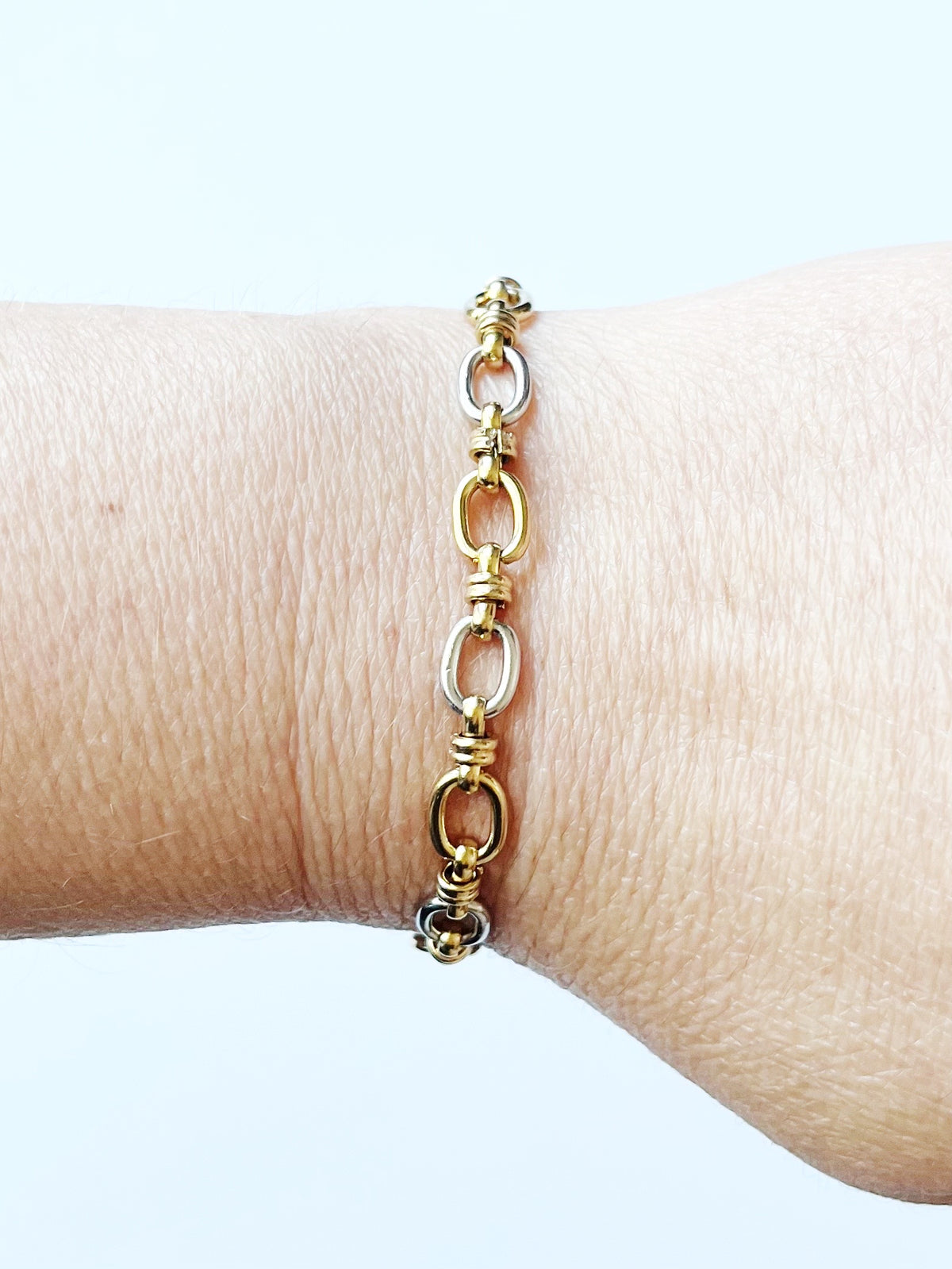 small mixed metal chain bracelet on wrist