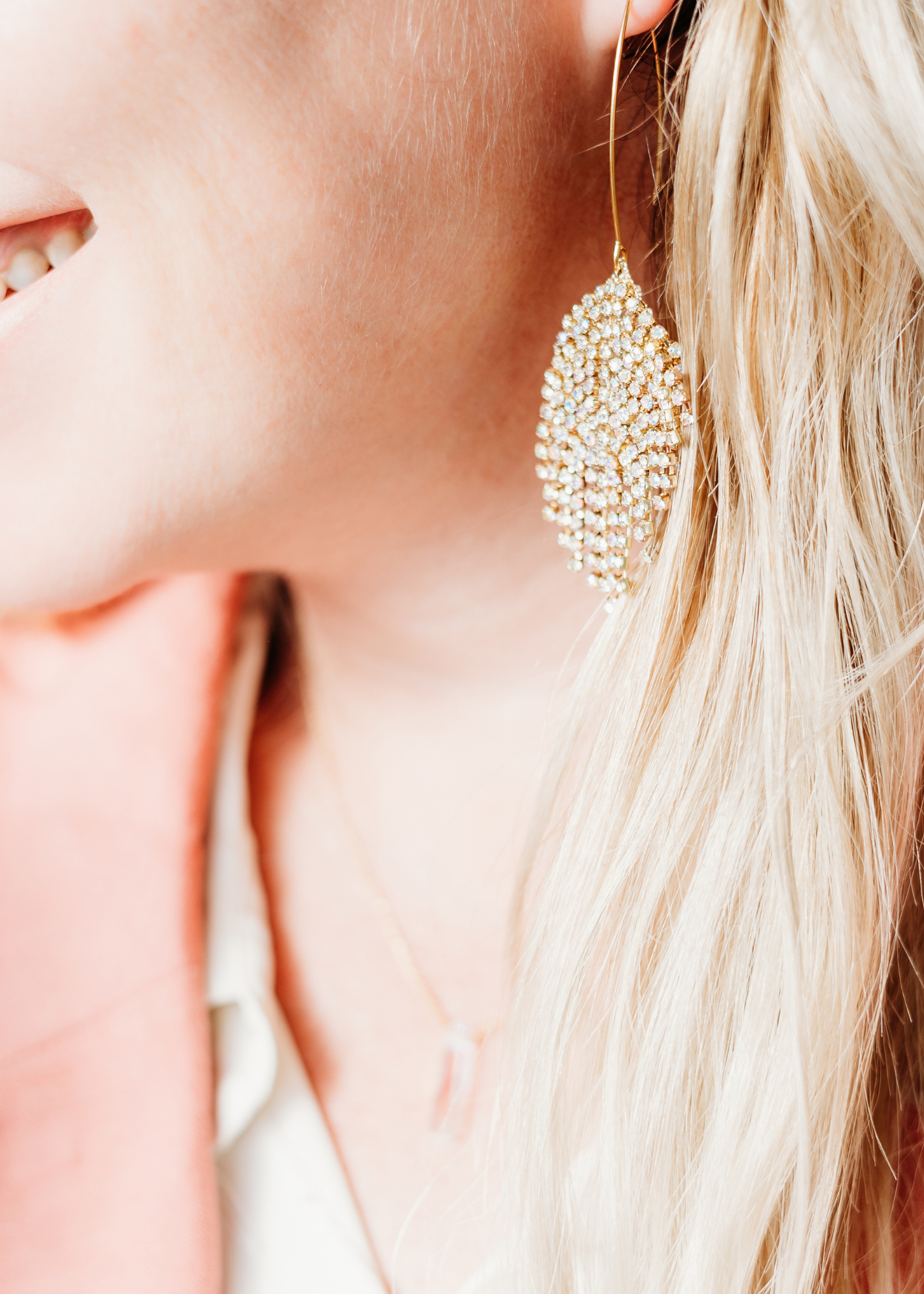 woman wearing gold dangle earrings