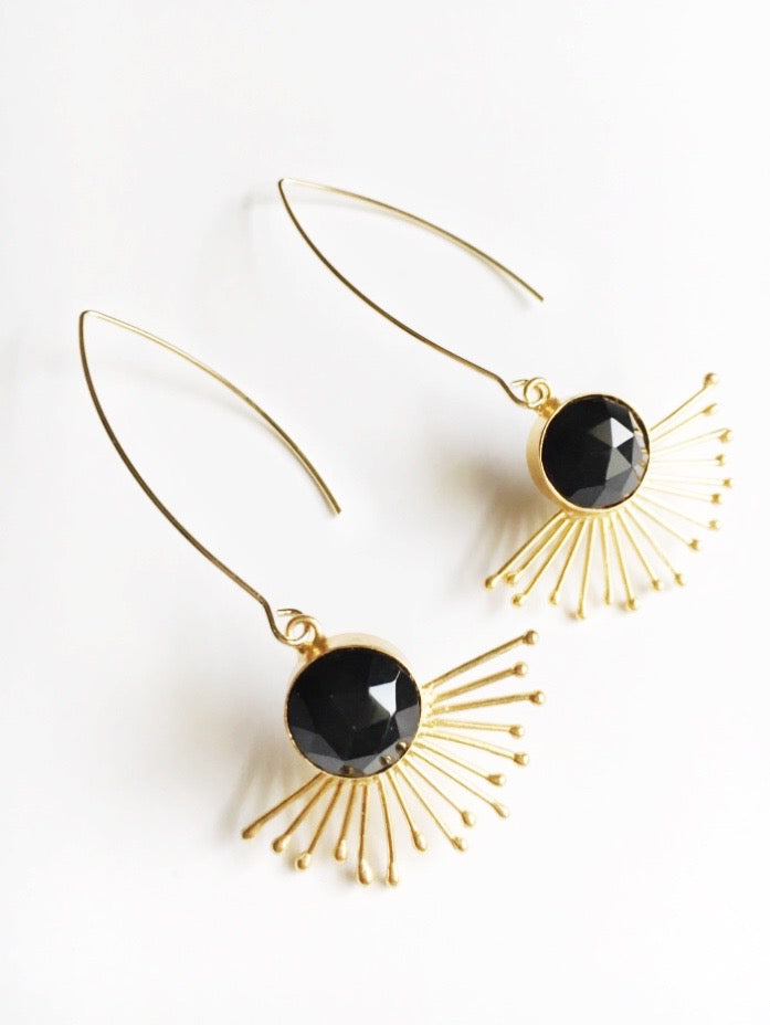 Gold sunburst and black onyx statement earrings.