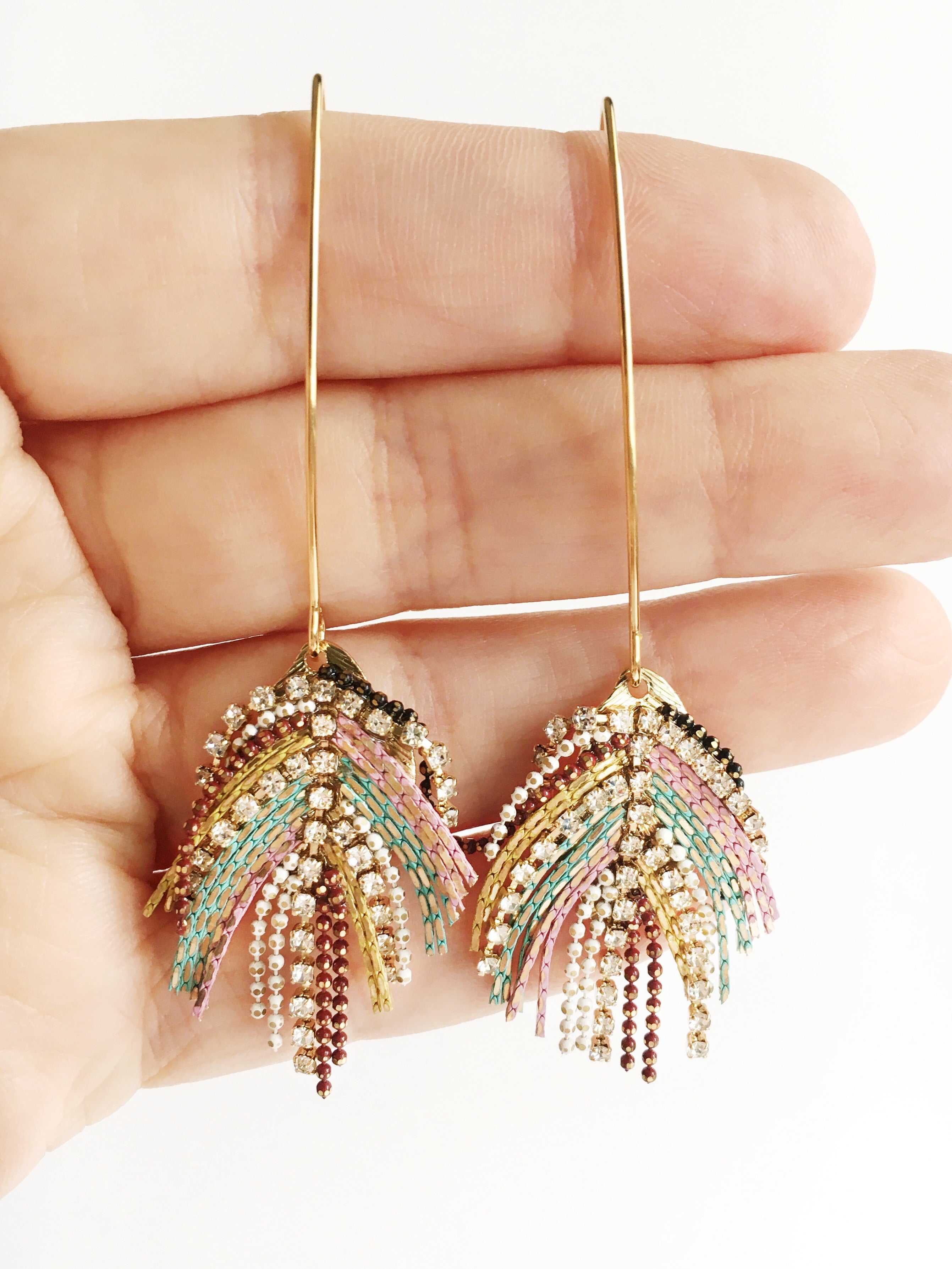 peacock boho earrings displayed on hand