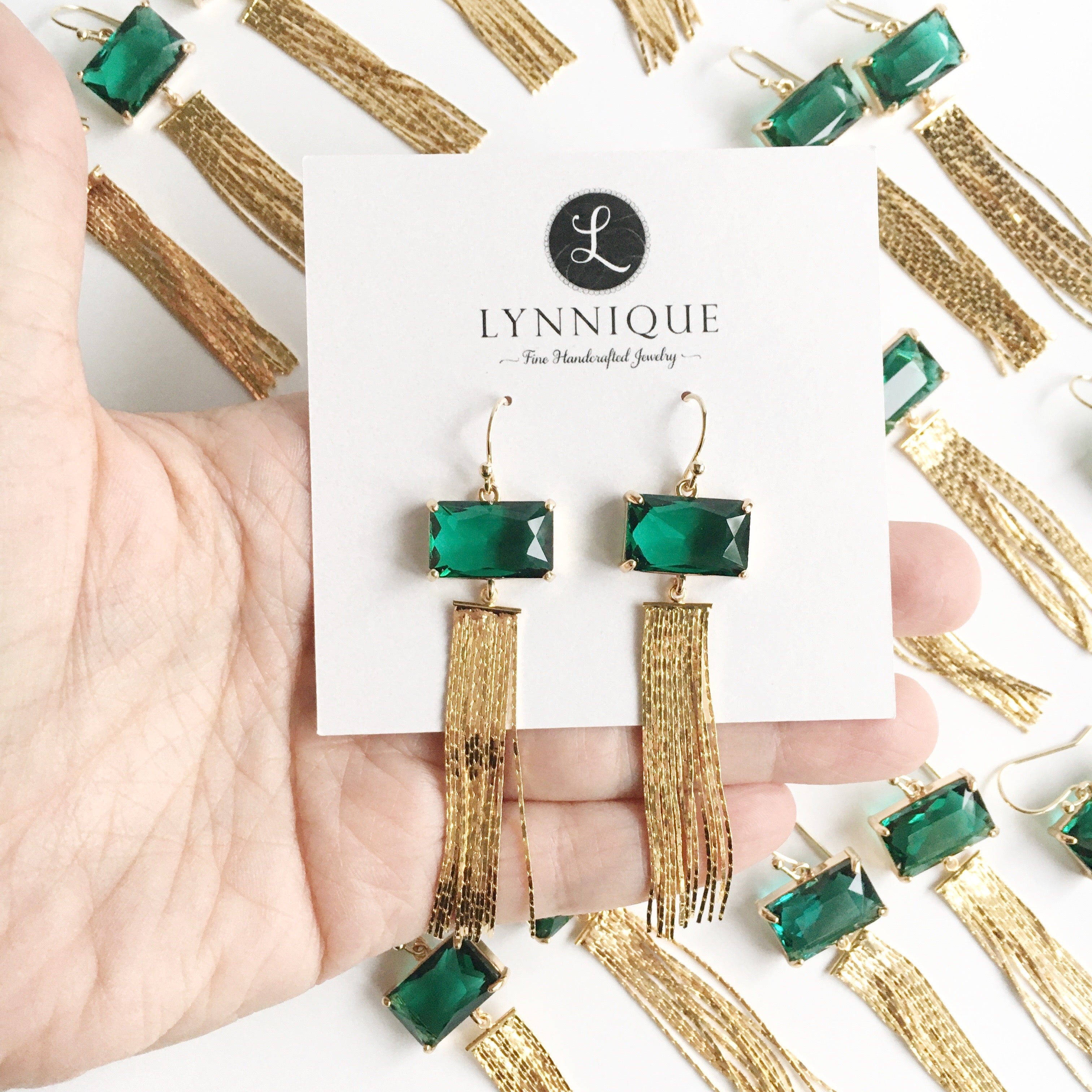 gold and green crystal drop earrings displayed on earring card