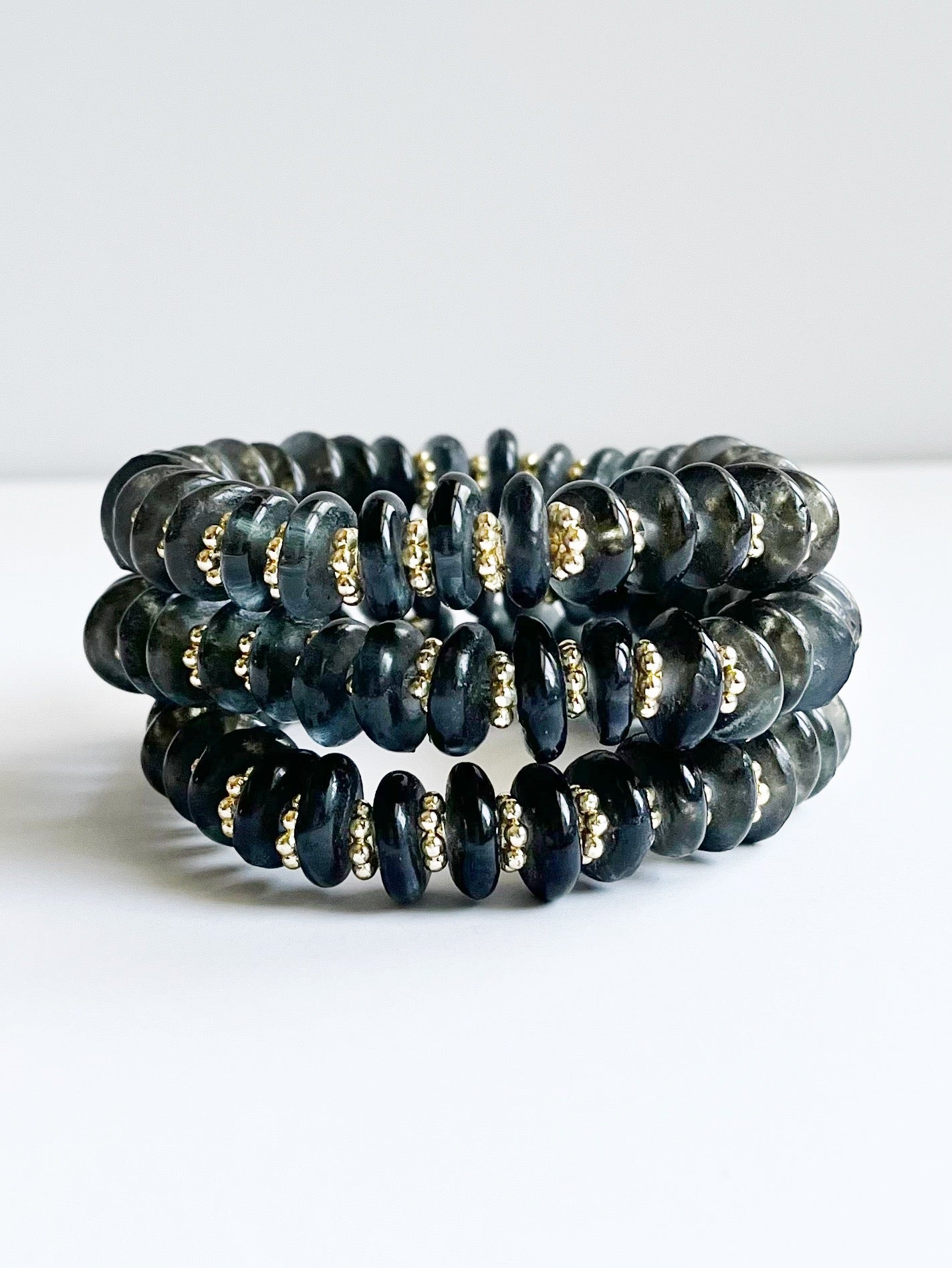 dark gray recycled glass and yellow gold bead bracelet stack