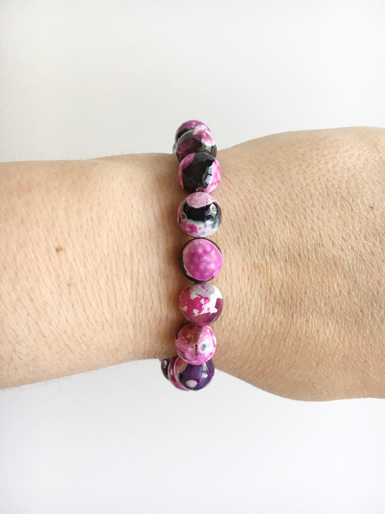 Women's wrist wearing Pink and Black Agate and Stardust Stainless Steel Beaded stretch Bracelet