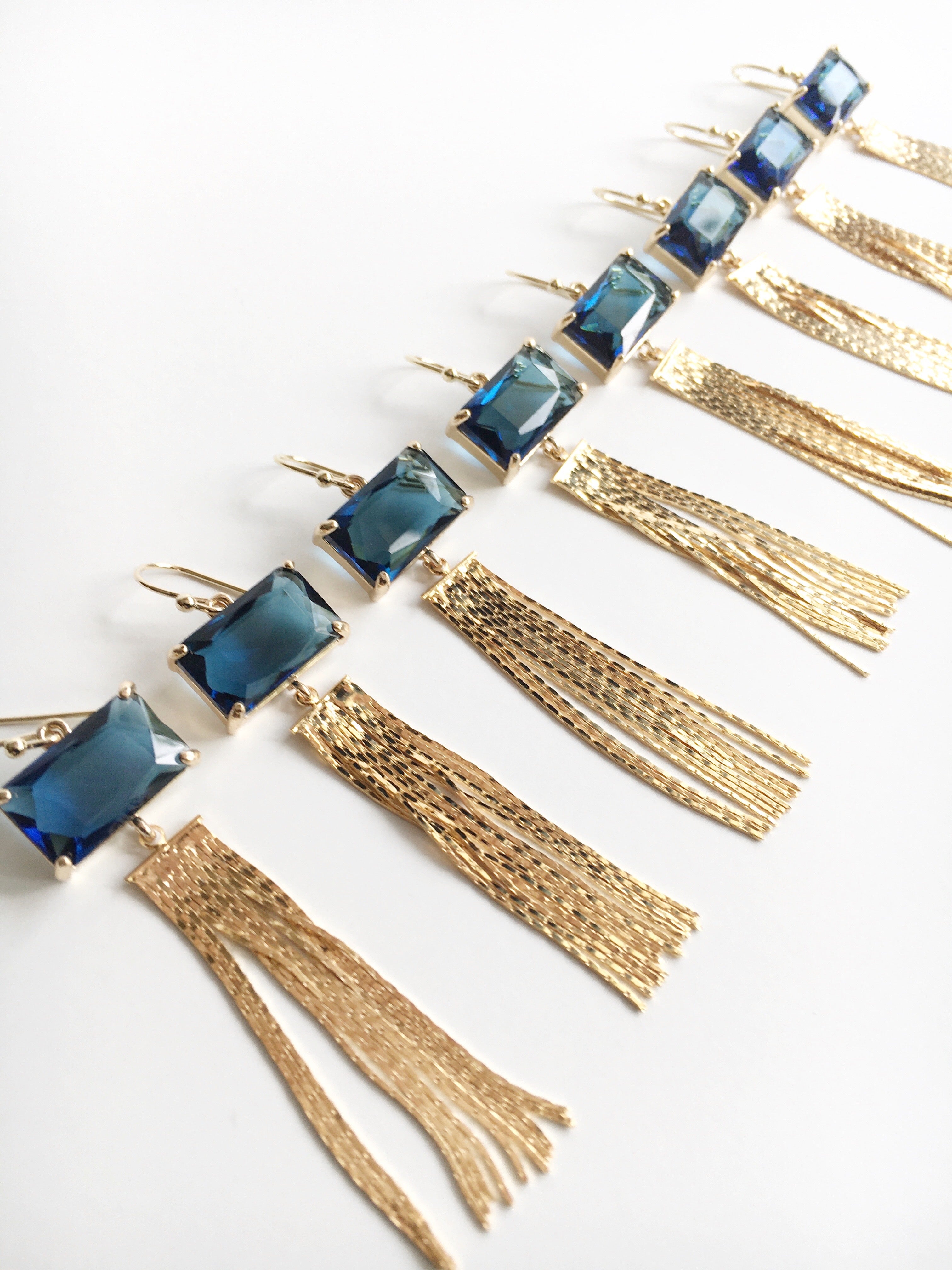 A line with several Sapphire Navy Blue and Gold Tassel Dangle Earrings