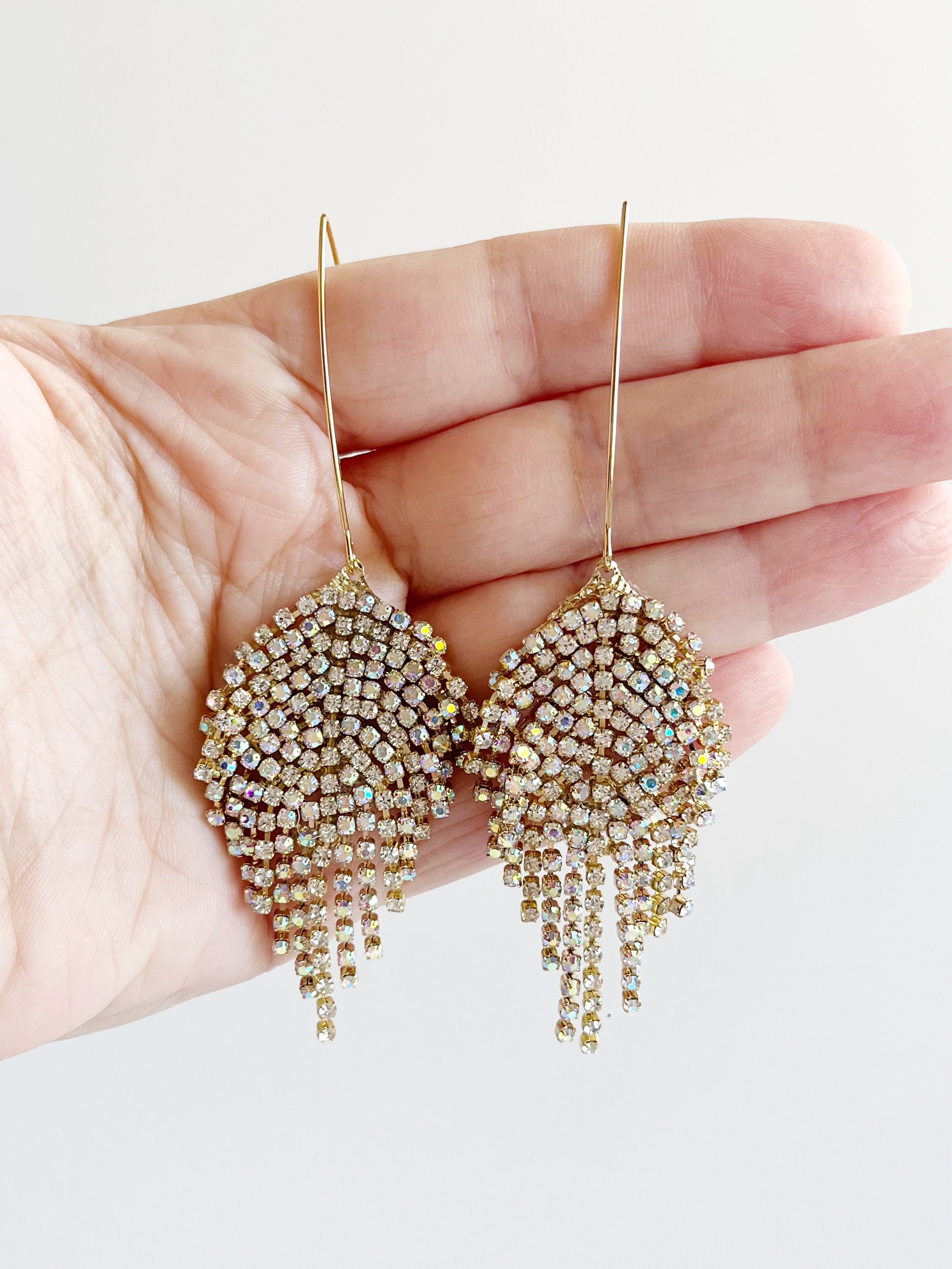 crystal pendant earrings displayed on hand