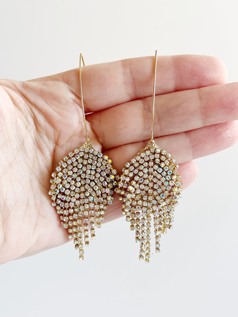 Crystal and Gold Statement Tassel Threader Earrings displayed on hand
