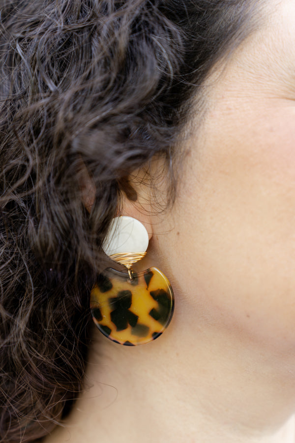 brown earrings on woman