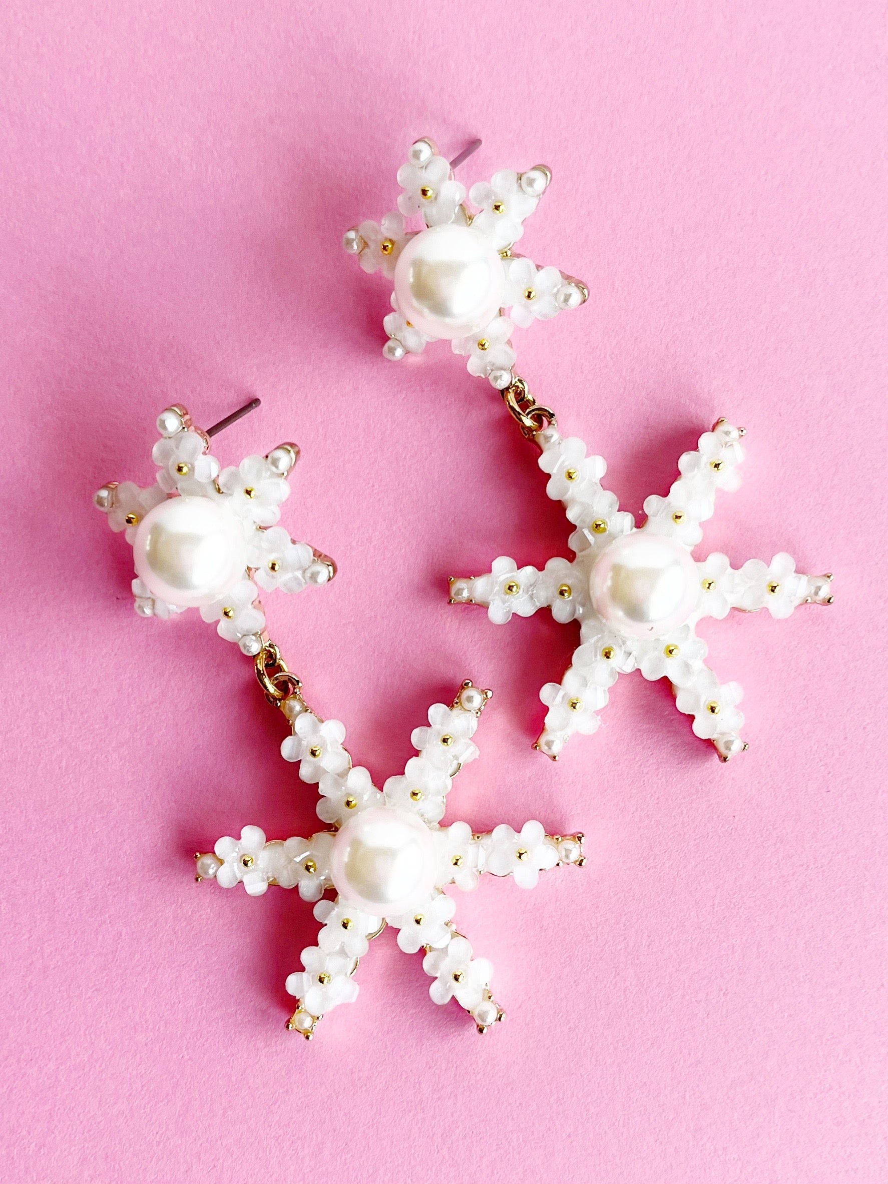 Pearl and Flower Star Pendant Statement Earrings on pink background